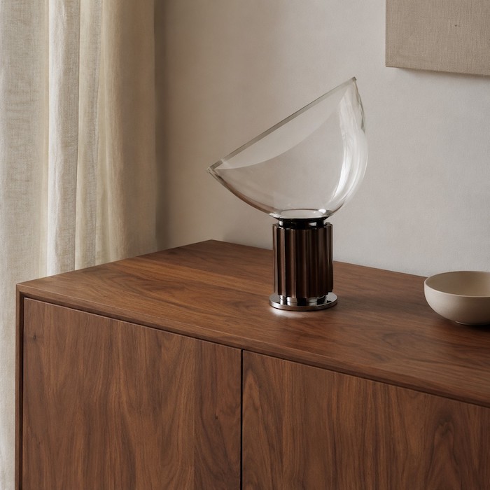 Bronze glass bowl table lamp connected naturally to walnut, linen and one matte ceramic object
