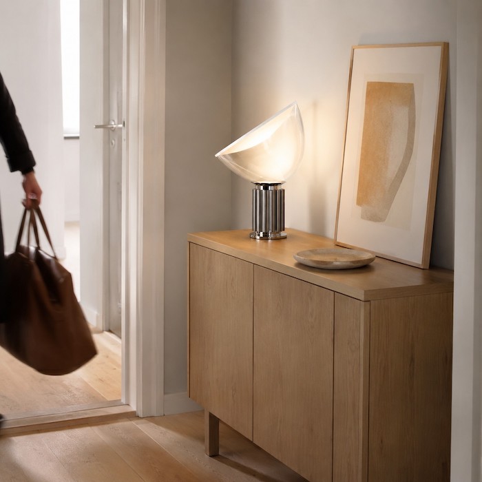 Silver glass bowl table lamp placed safely on pale oak in a compact European entrance