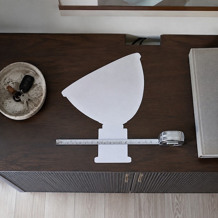 Large paper lamp footprint tested on a broad console before replacement