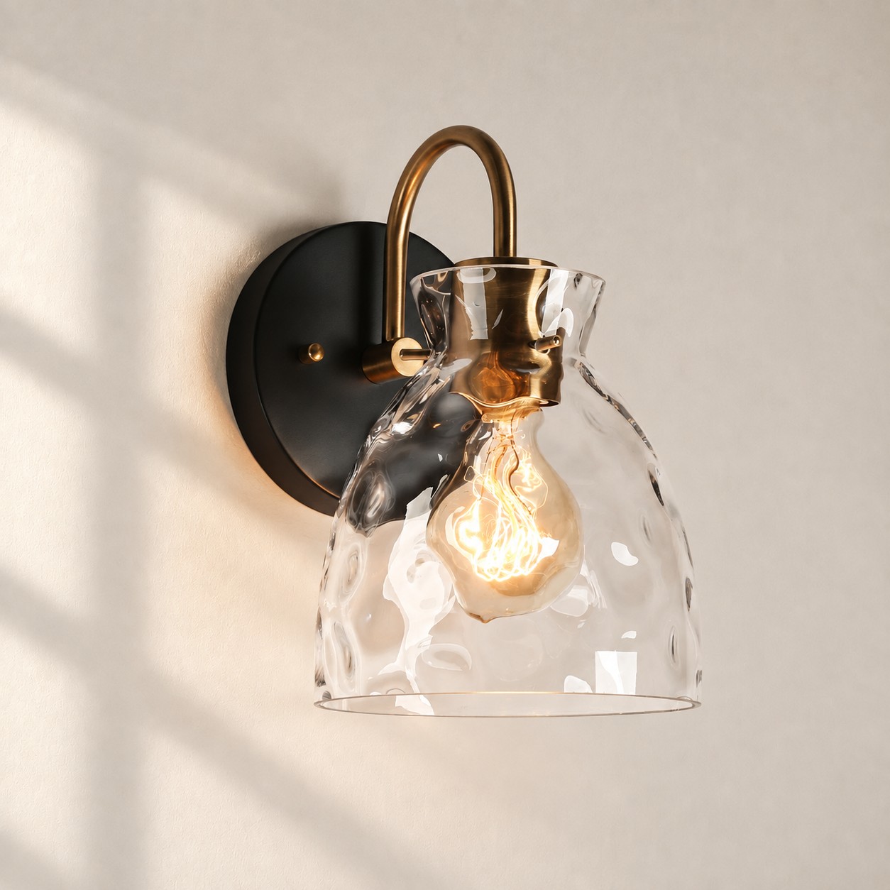 Textured Glass Wall Sconce with a clear shade and a curved arm
