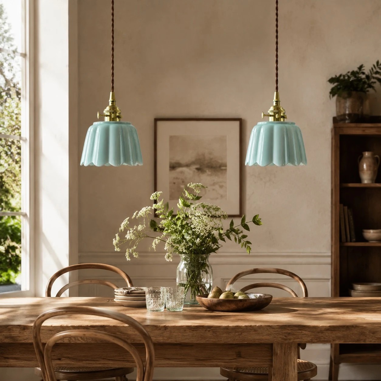 Pair of ceramic lotus pendant lights over a dining table