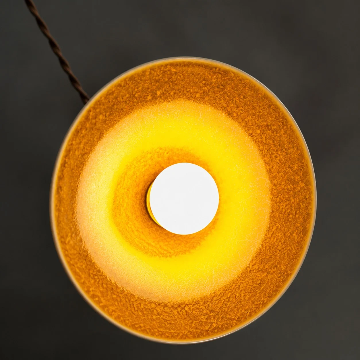 Underside view of the yellow ceramic glaze and open bulb area