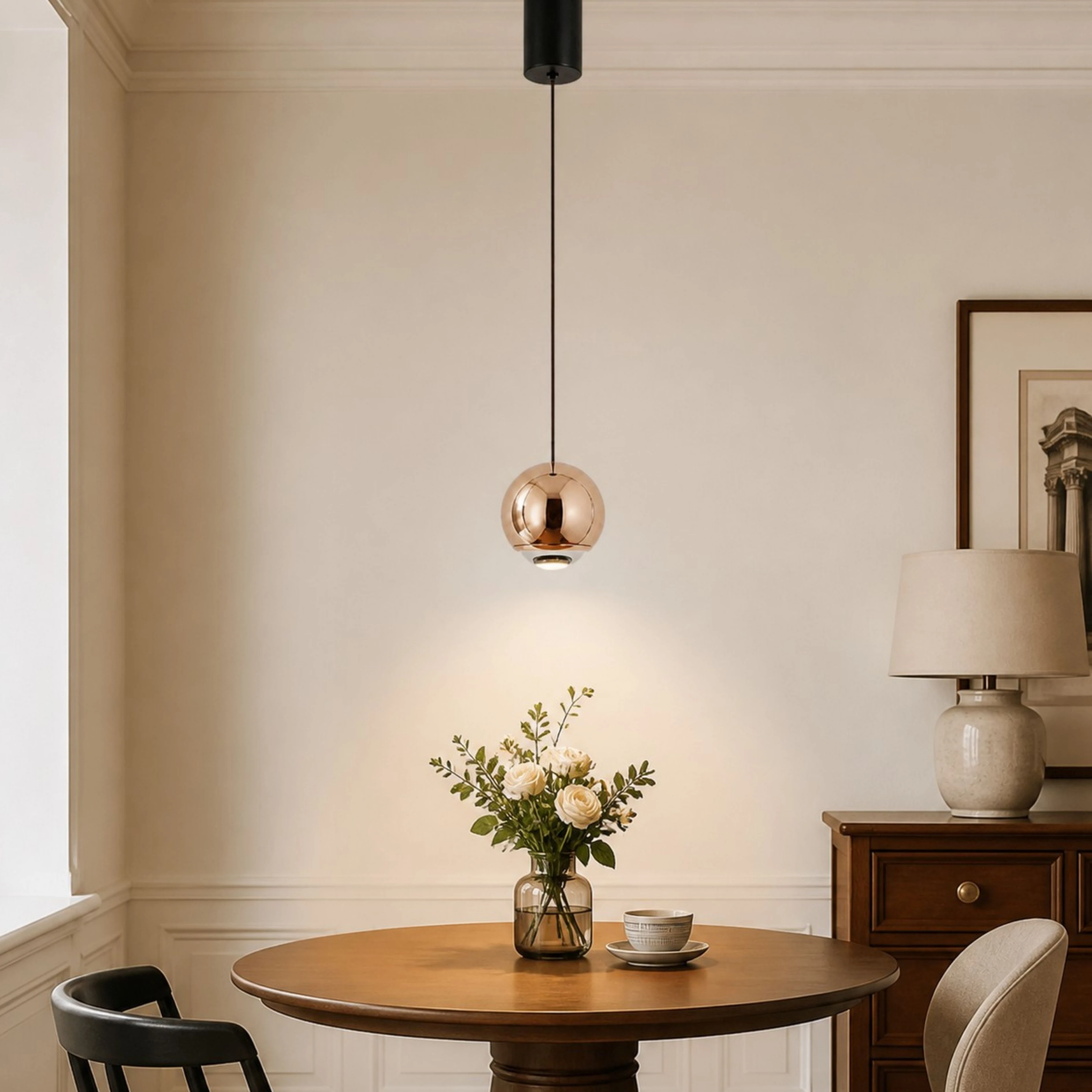 Rose Gold orb pendant above a dining table