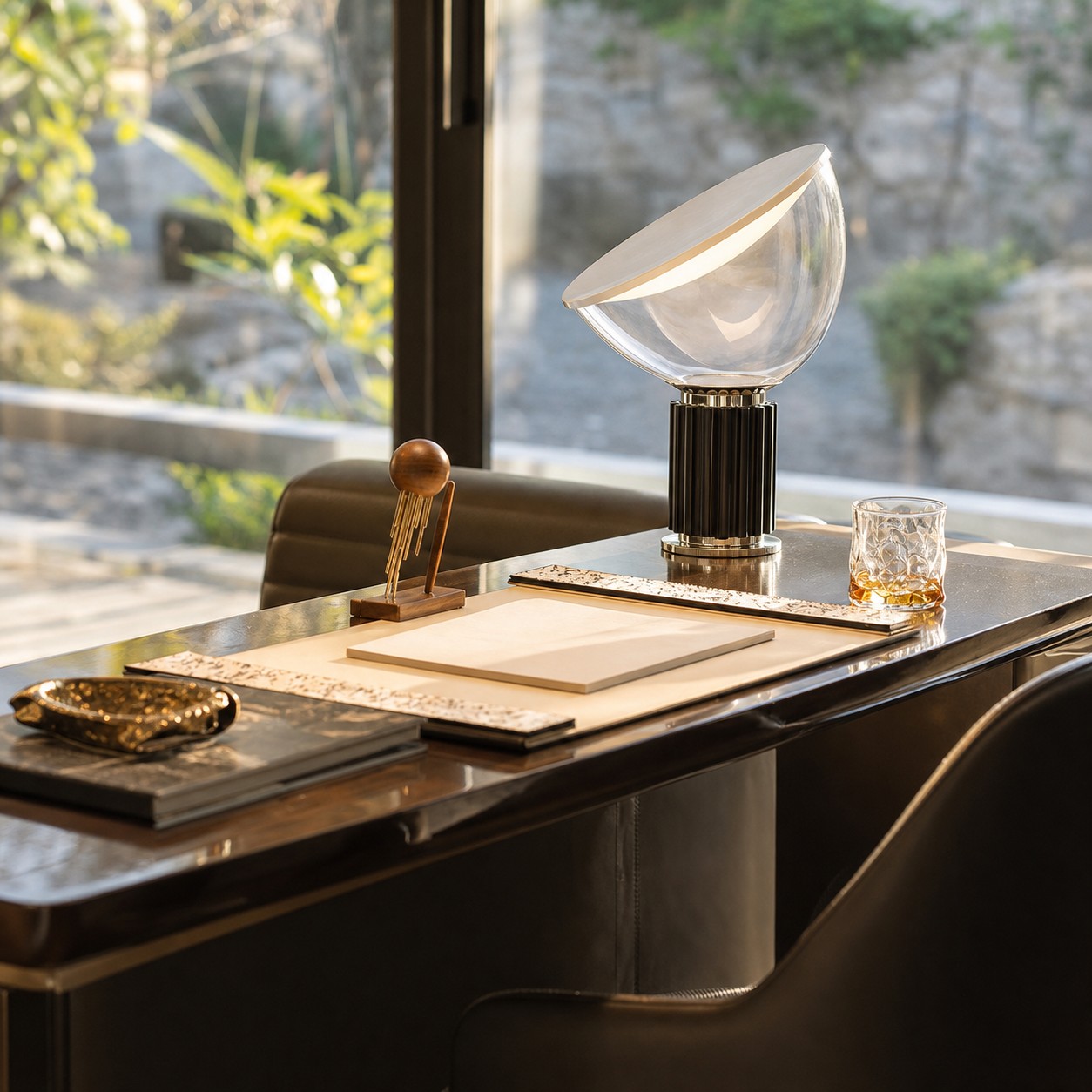 Black Taccia lamp beside a sunlit window