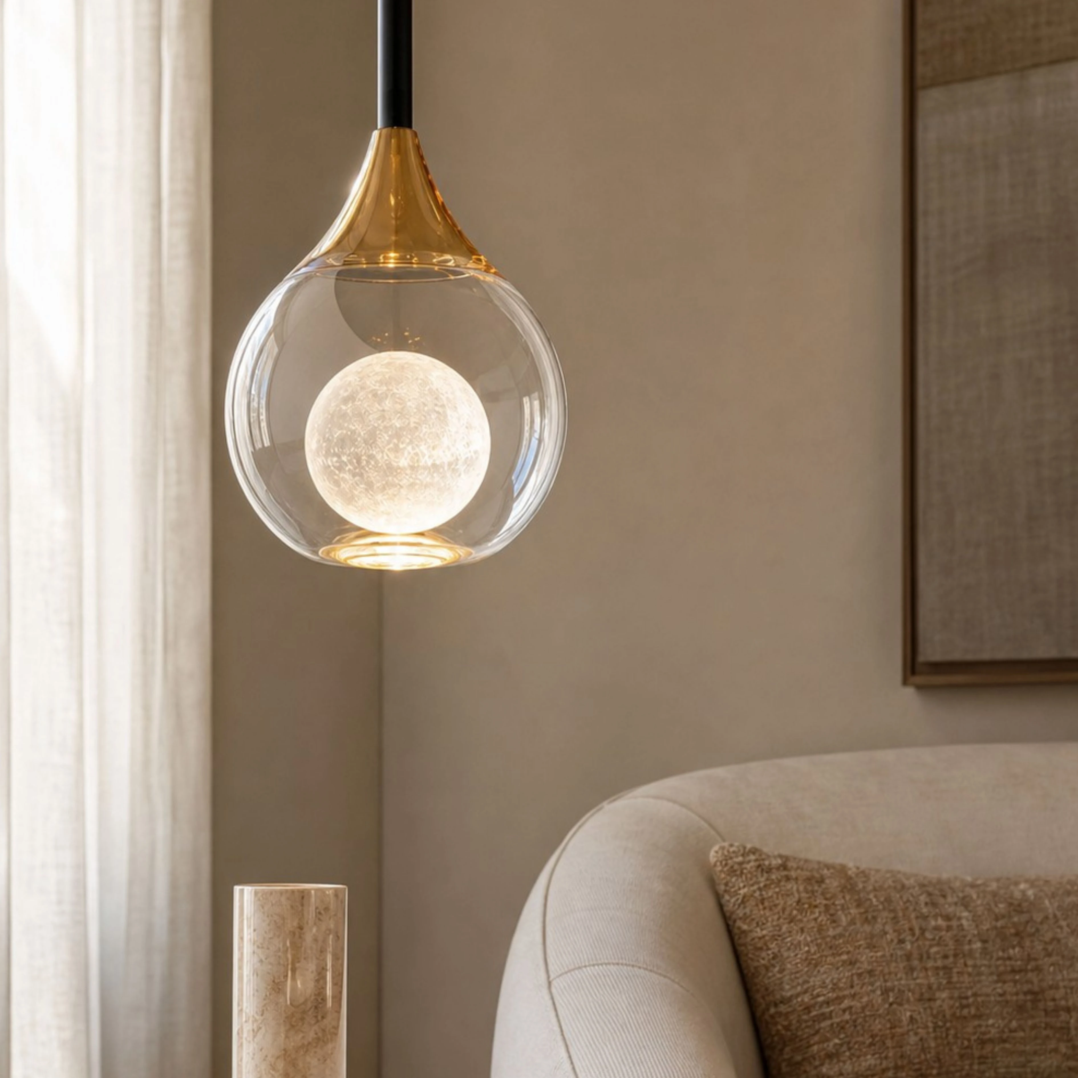 Gold Luma pendant illuminated in a warm interior