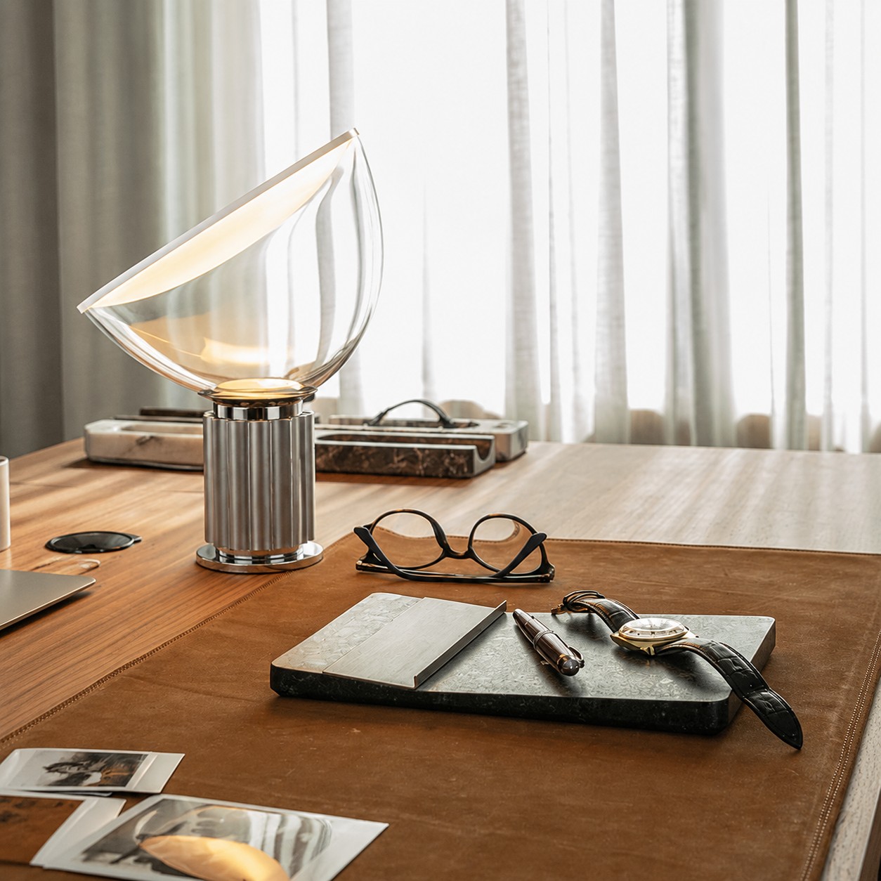 Silver Taccia lamp on a leather writing desk
