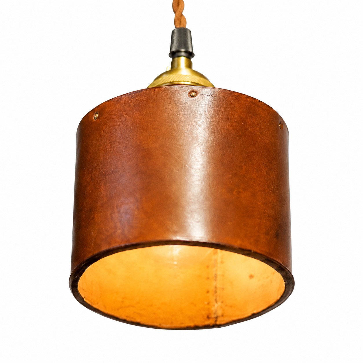 Close-up of the brown leather cylinder shade and warm inner glow