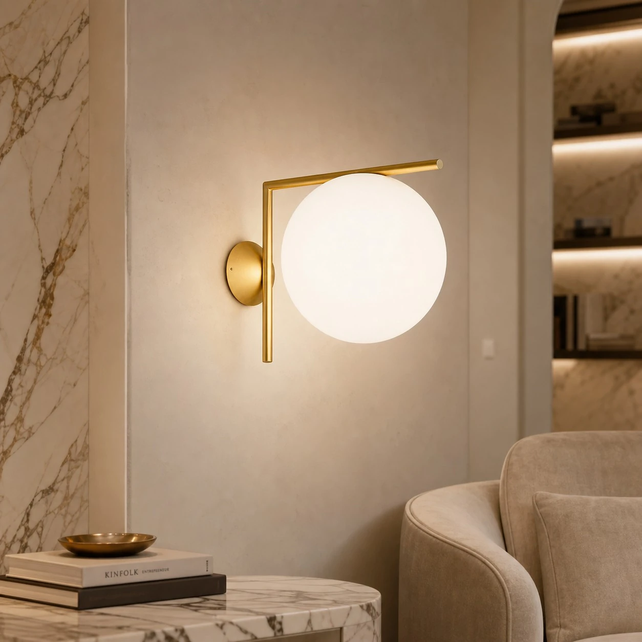 Gold offset globe wall sconce in a reading corner