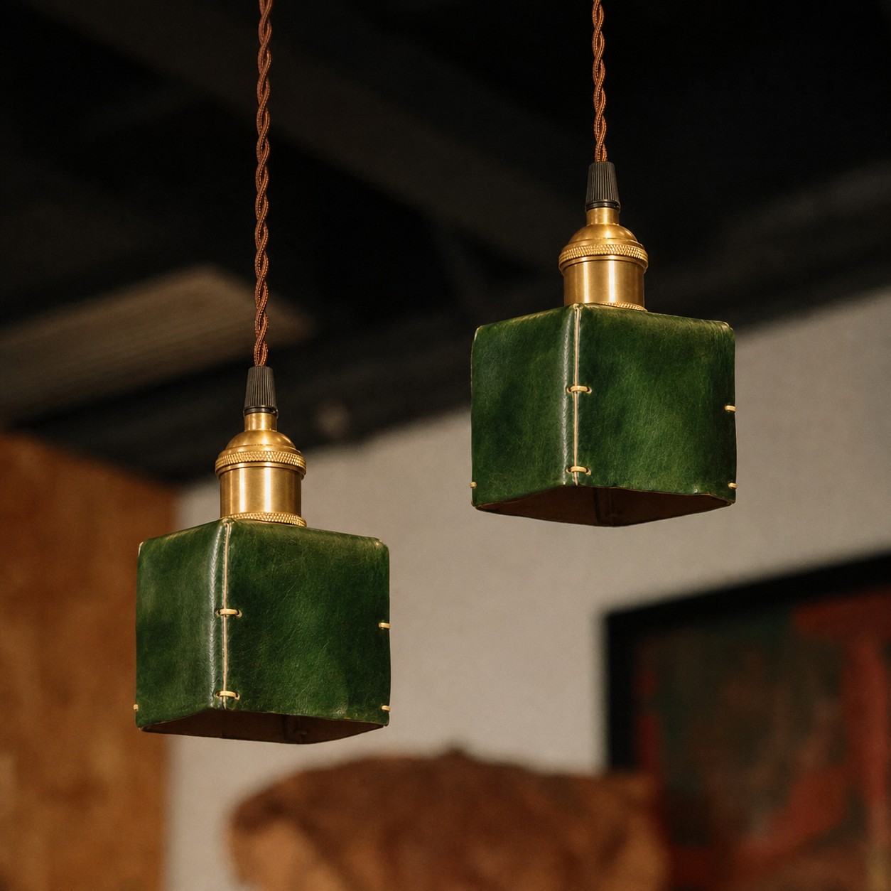 Two ink green hand-shaped leather pendant lights
