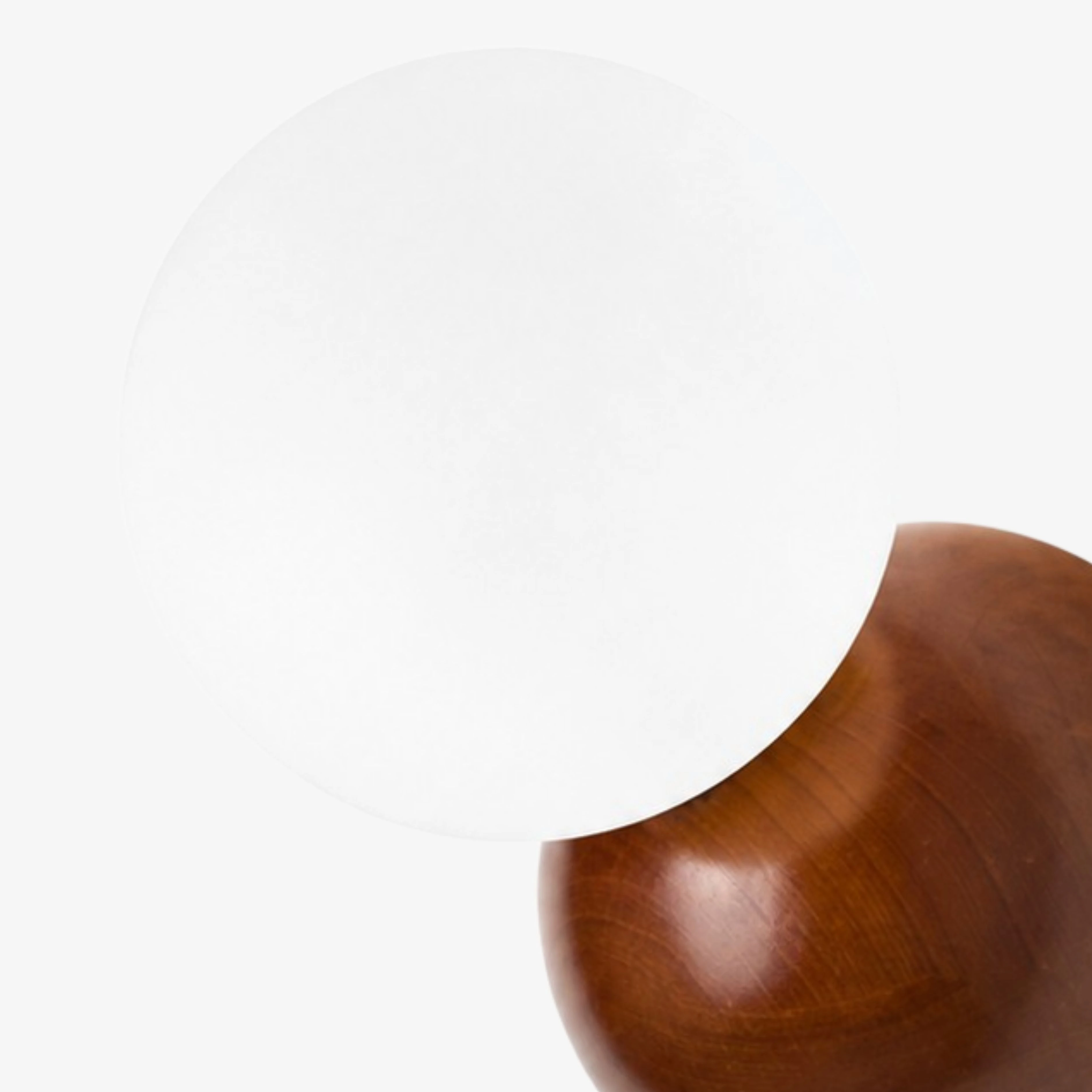 Opal glass globe detail on walnut wall sconce