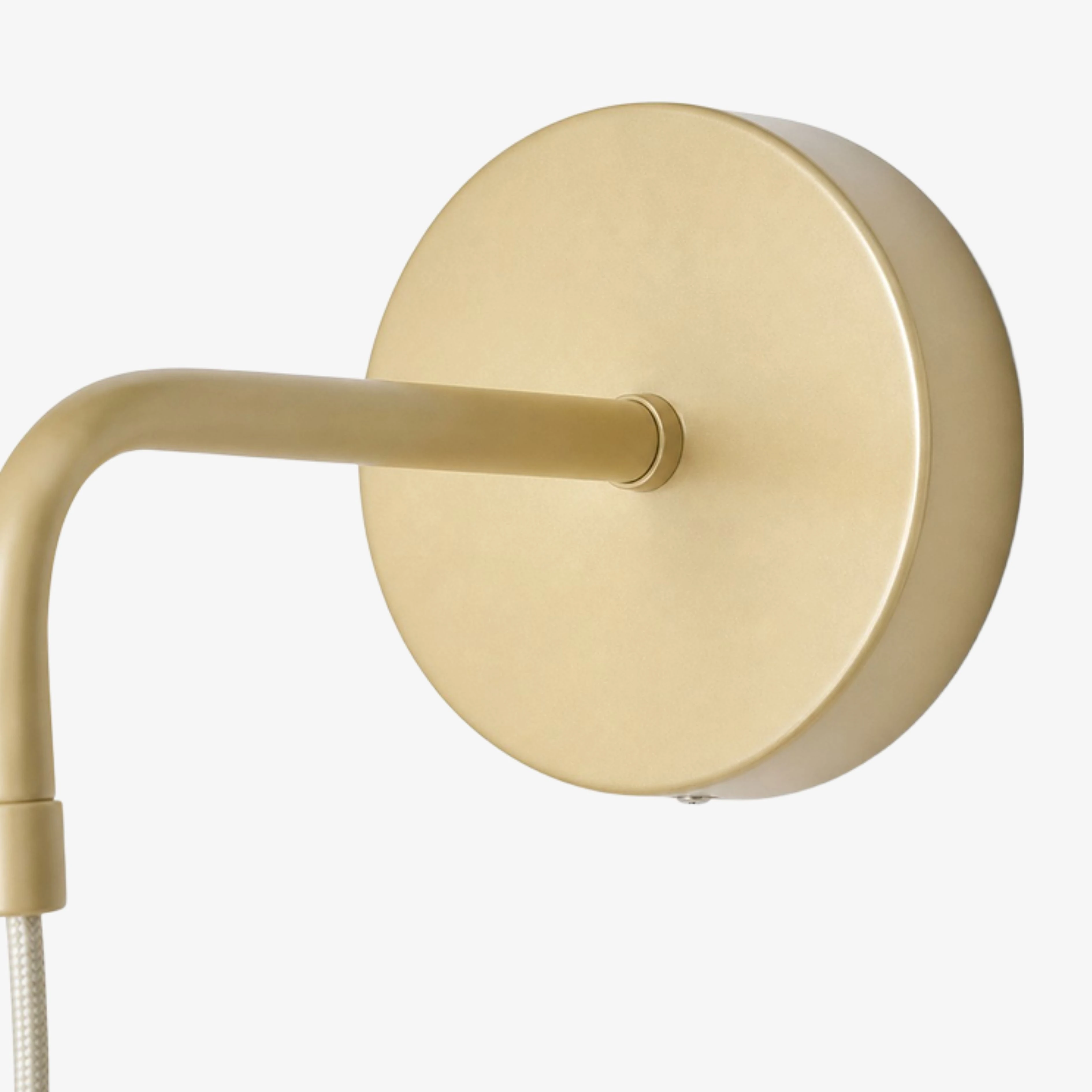 Close view of the brushed gold wall backplate and arm