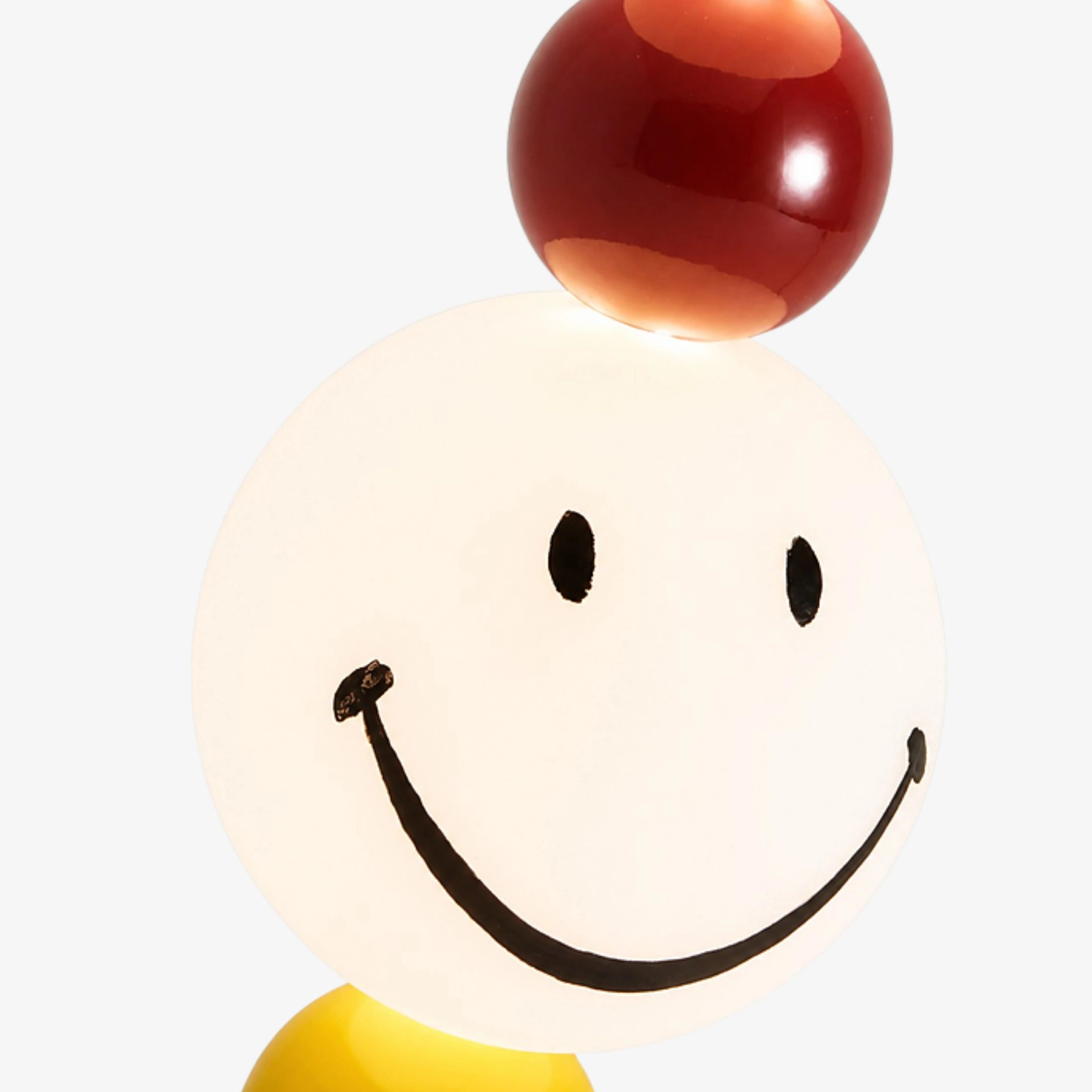 Close view of the illuminated smiley globe and red accent sphere