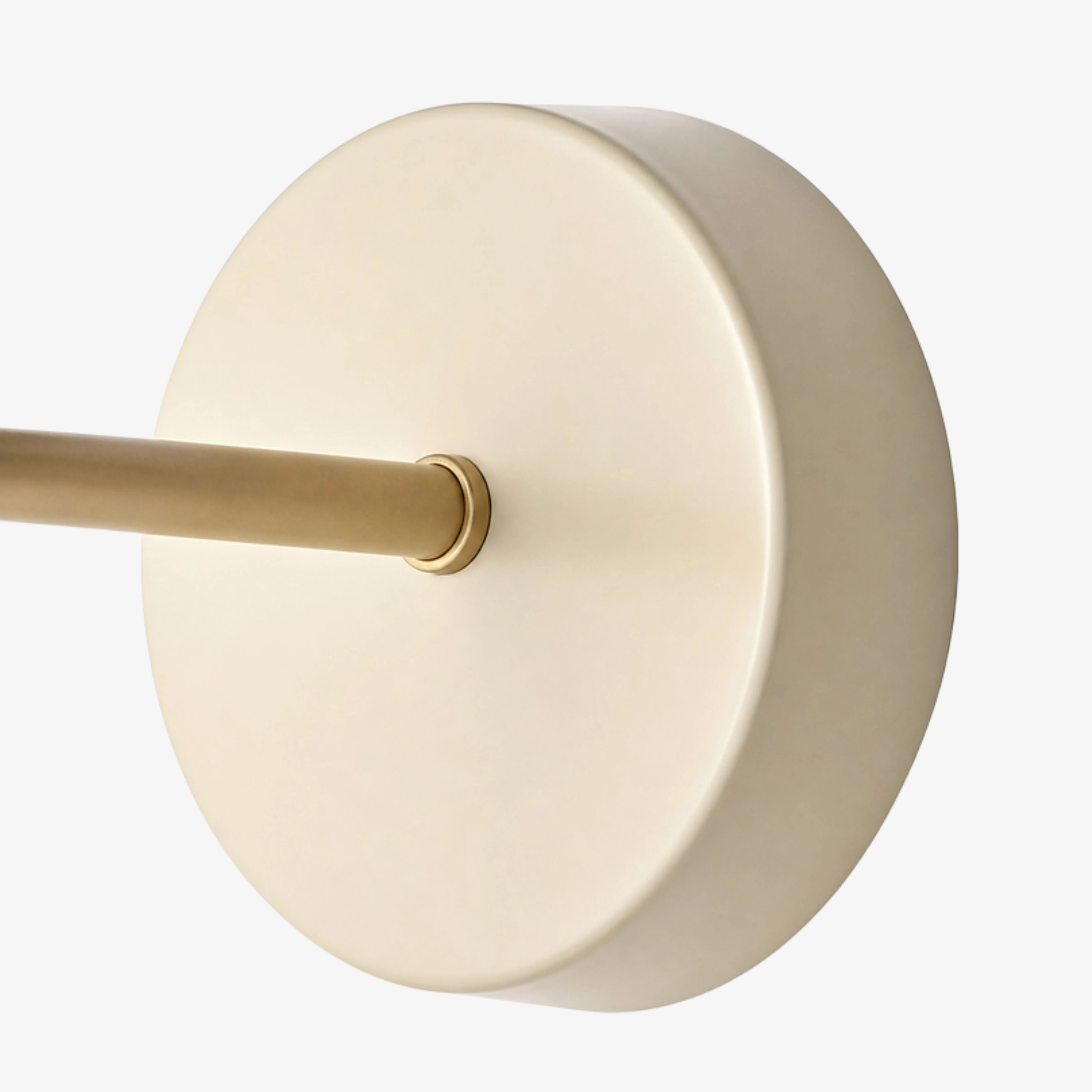Close view of the cream backplate and brushed gold arm