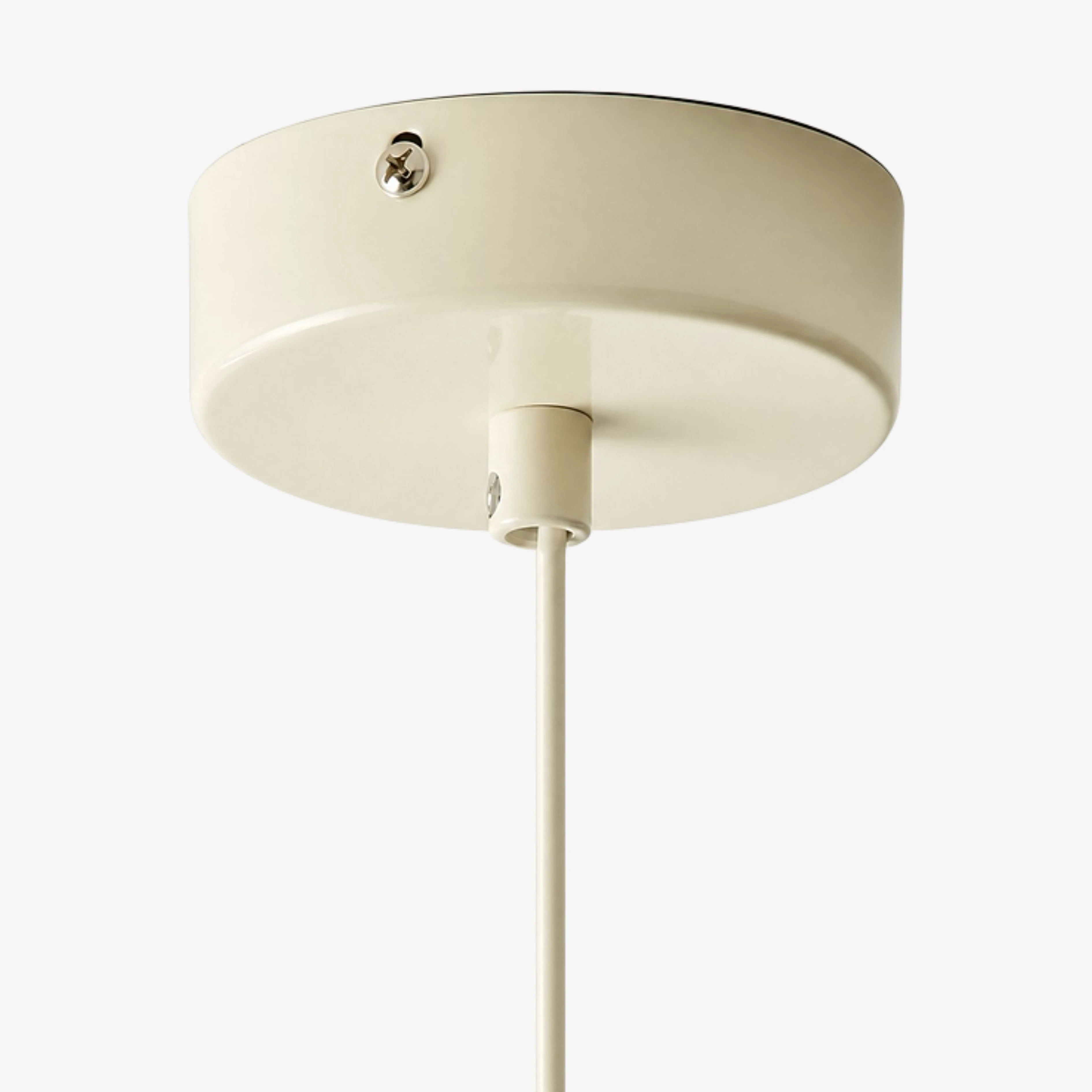 Close view of the cream ceiling canopy and suspension cable