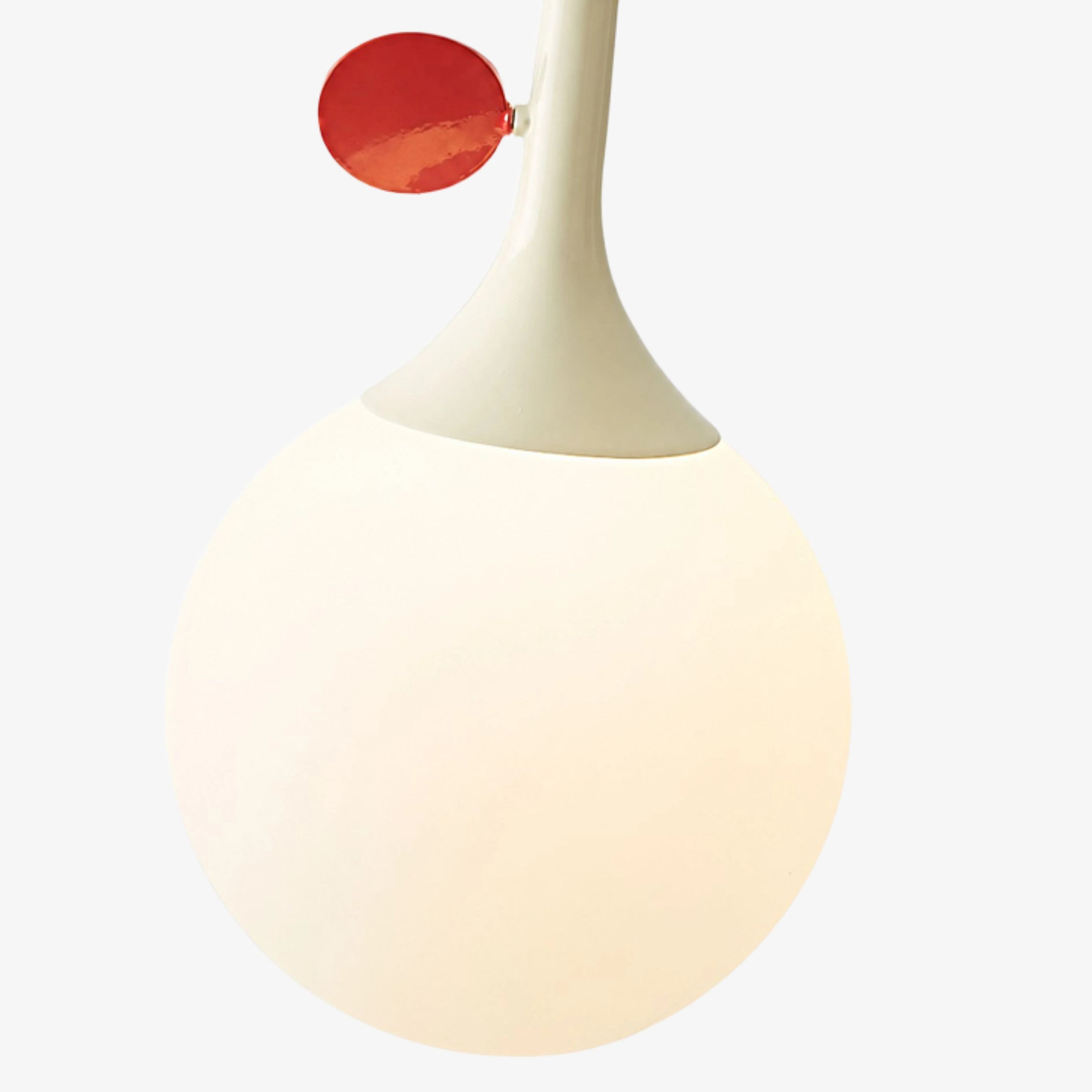 Close view of the cream globe and red orbit disc