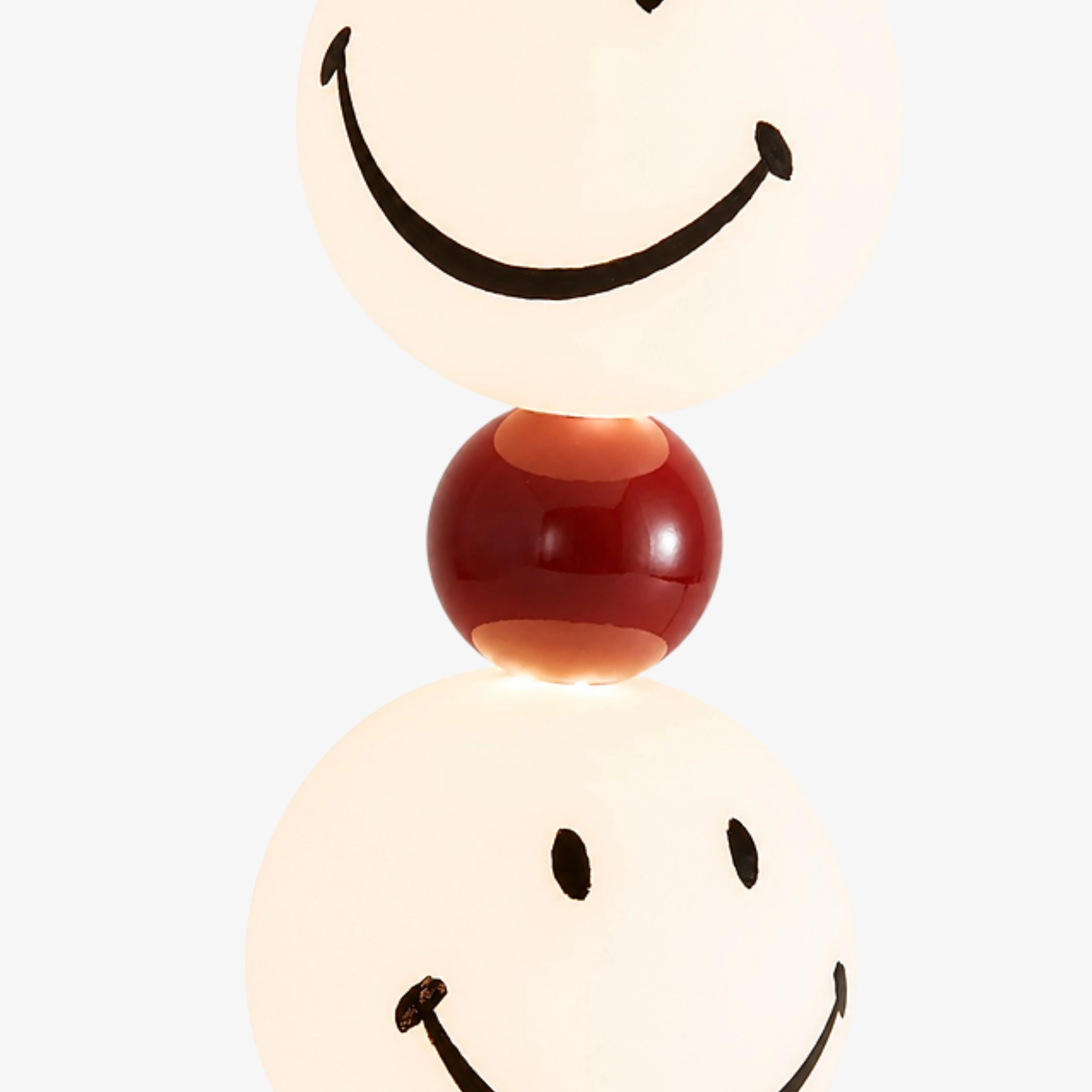 Close view of the stacked globes and glossy red center sphere