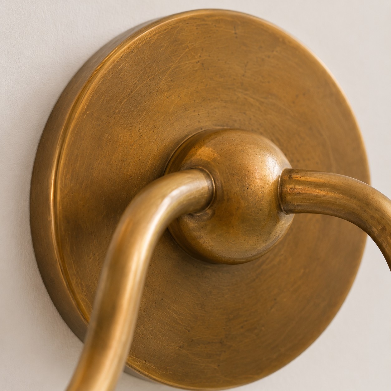 Tumbled brass double-arm wall plate close-up