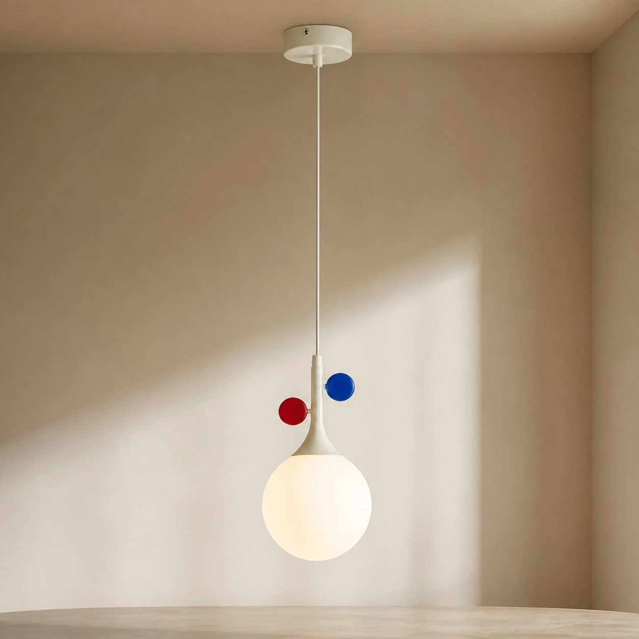 Cream orbit-disc pendant in a close dining-area scene