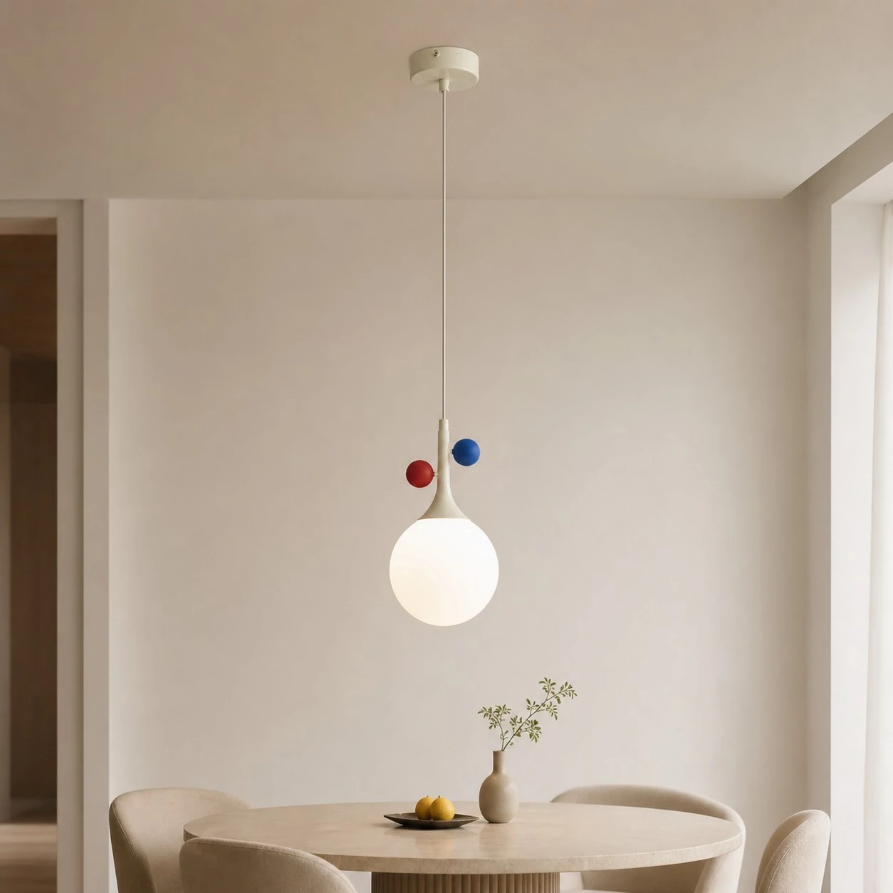 Cream orbit-disc pendant above a wide dining-room setting