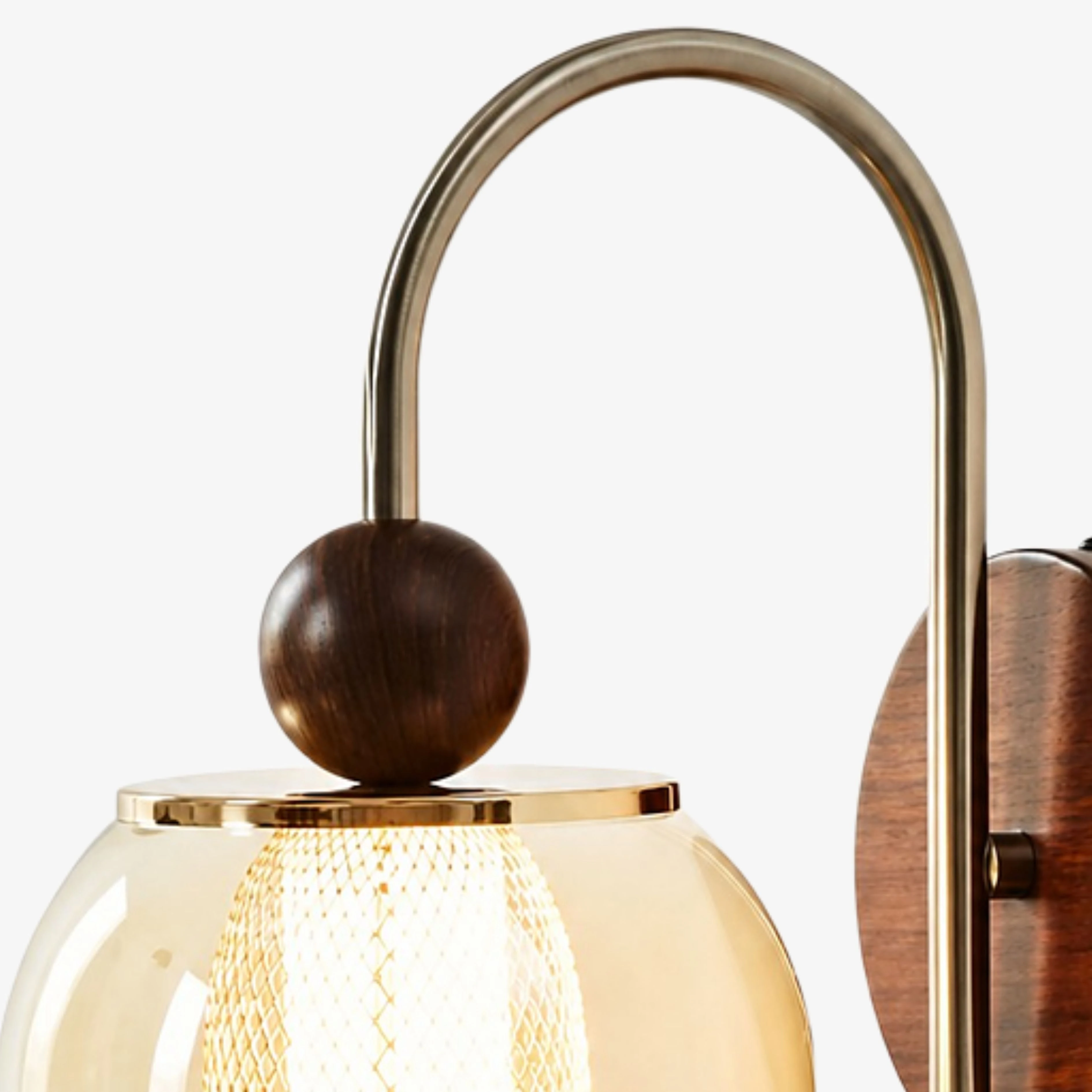 Close view of the arched metal arm and wood accent sphere