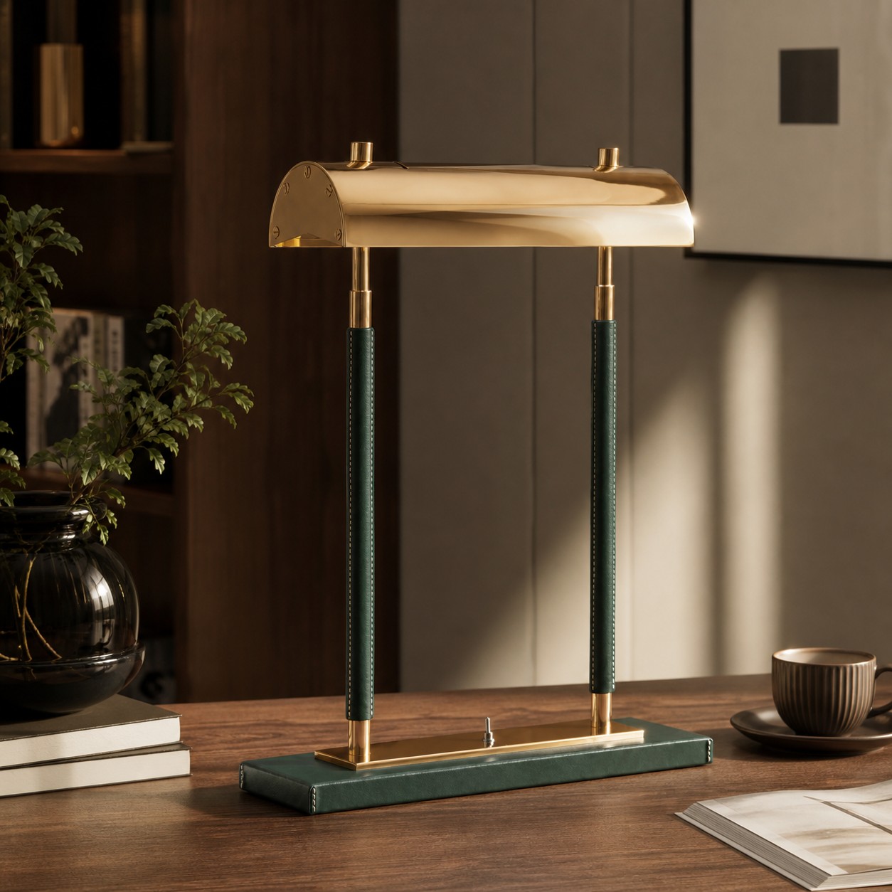 Green leather double-column table lamp on a wood desk