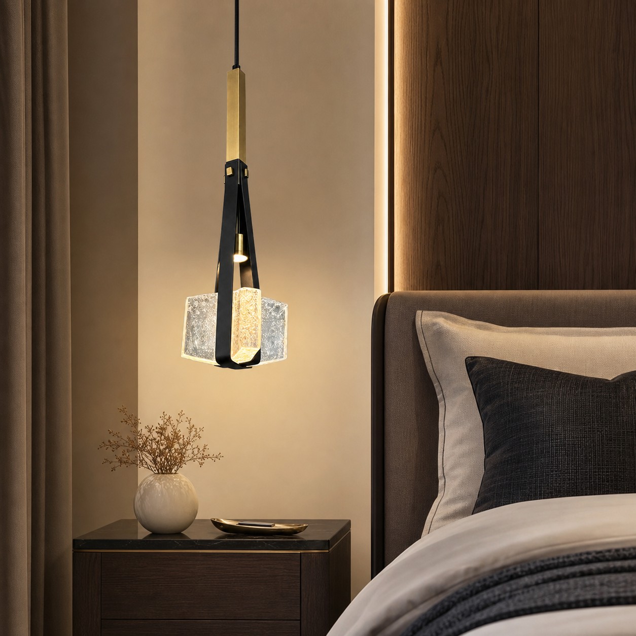 Black leather and bubble glass pendant lamp beside a bed