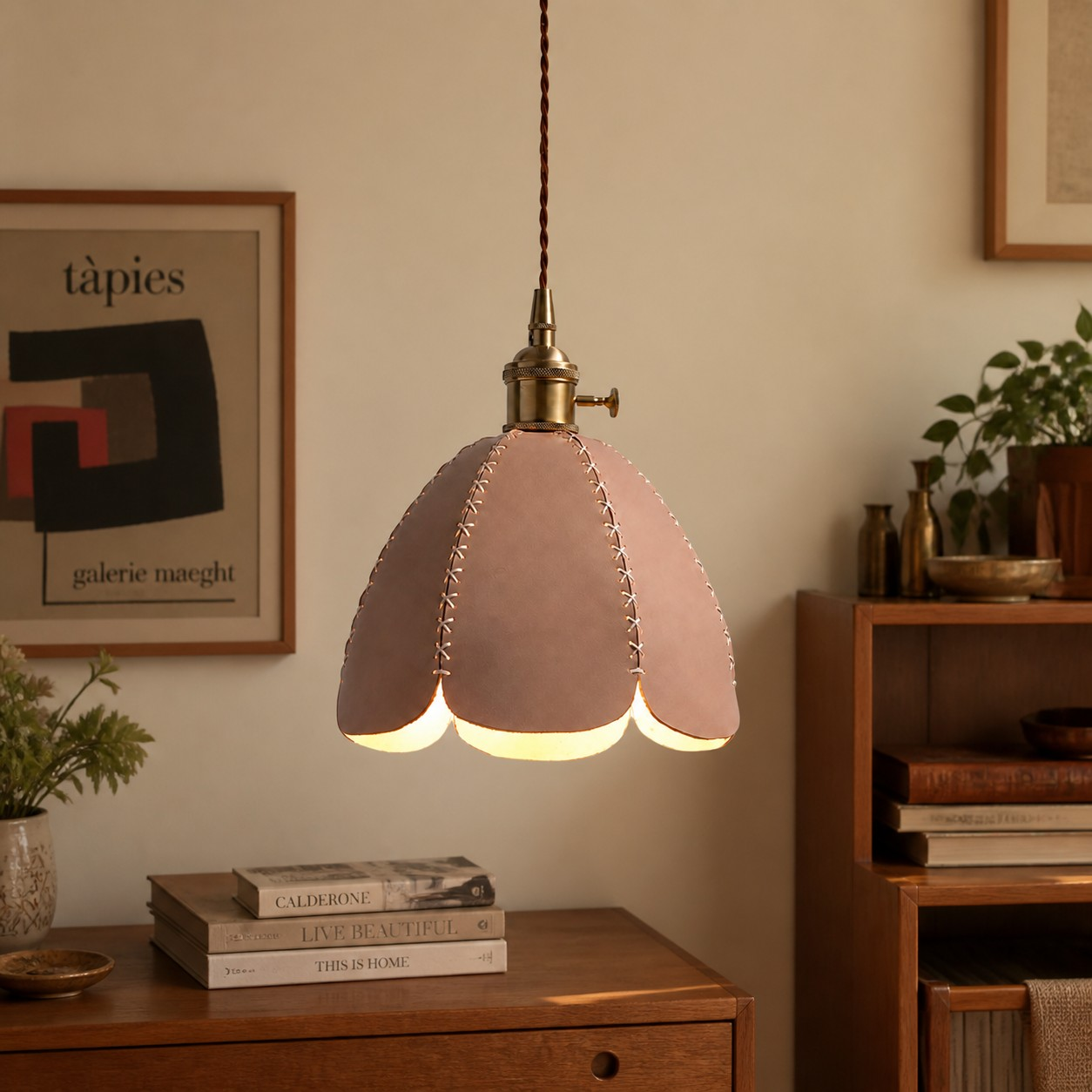 Natural leather petal pendant lamp above a wood desk