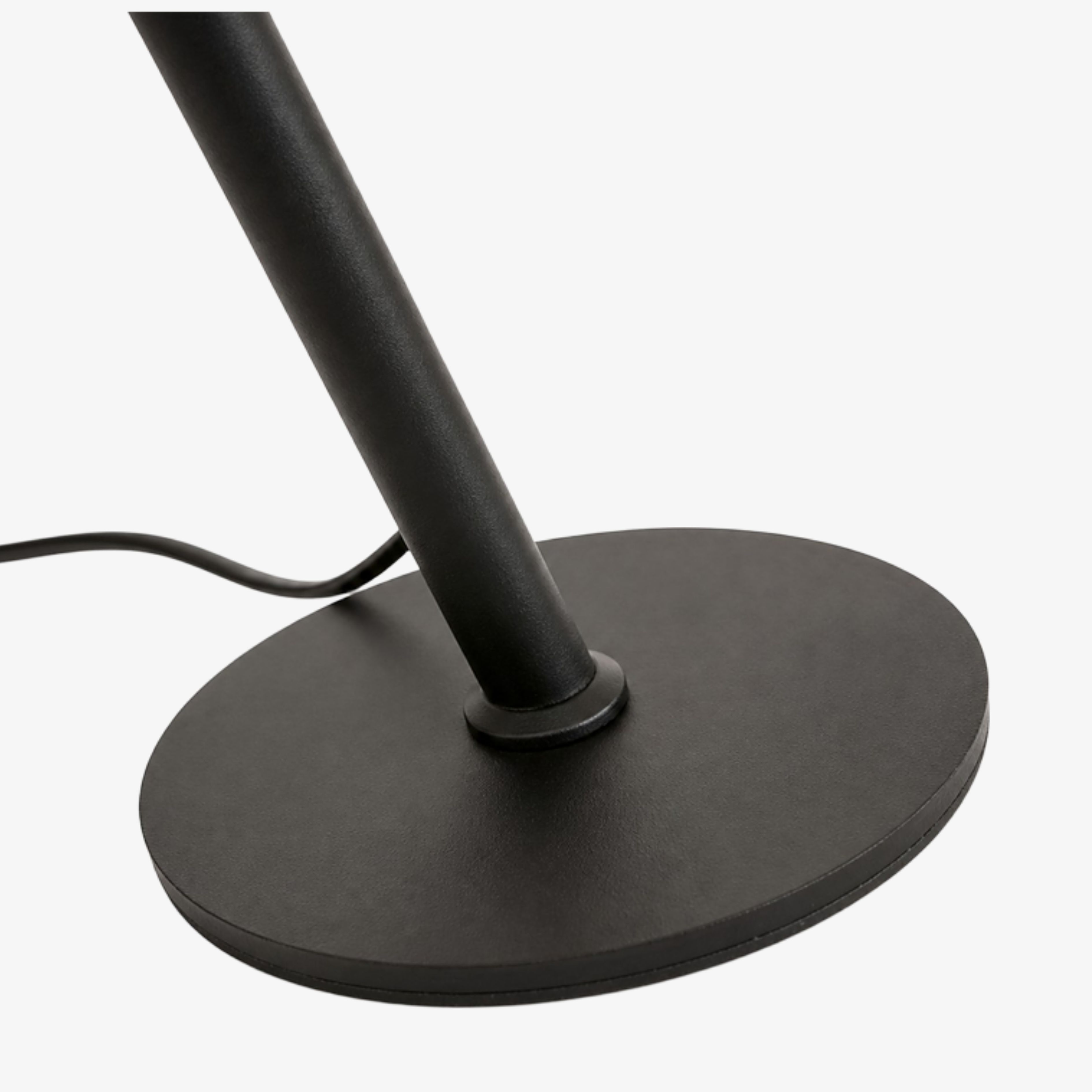 Dark metal stem and round base detail