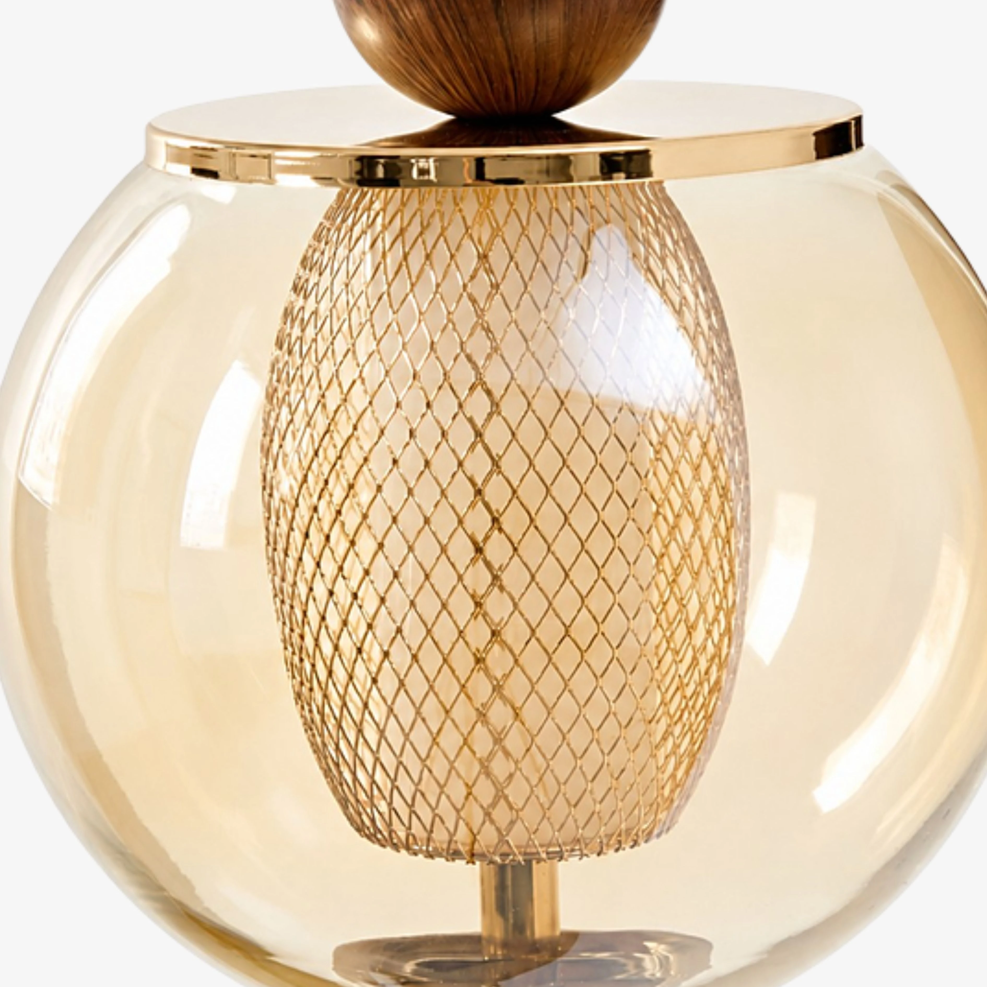 Close view of the amber glass globe and woven metal diffuser