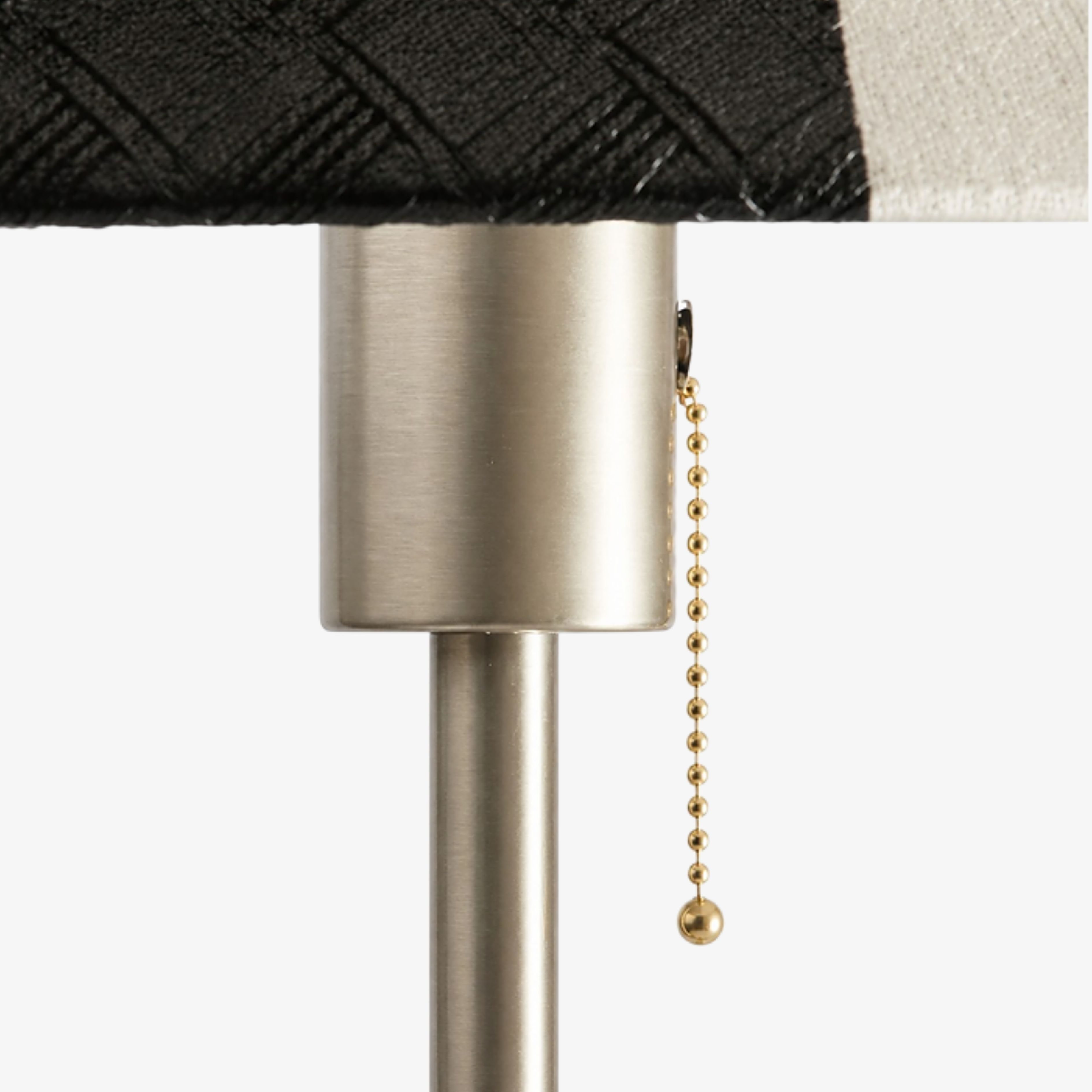 Pull-chain switch beneath the striped leather shade