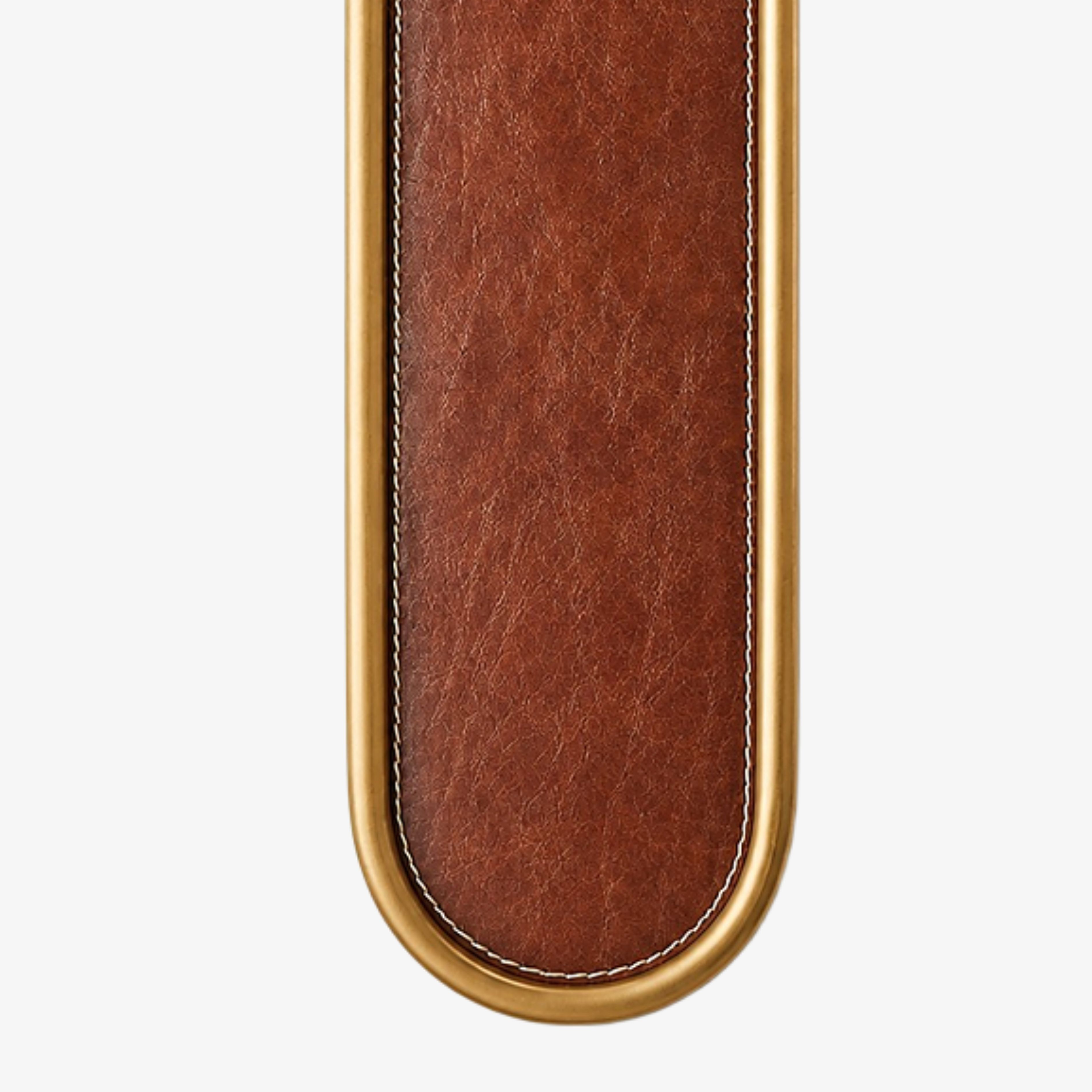 Close view of smooth brown leather with edge stitching