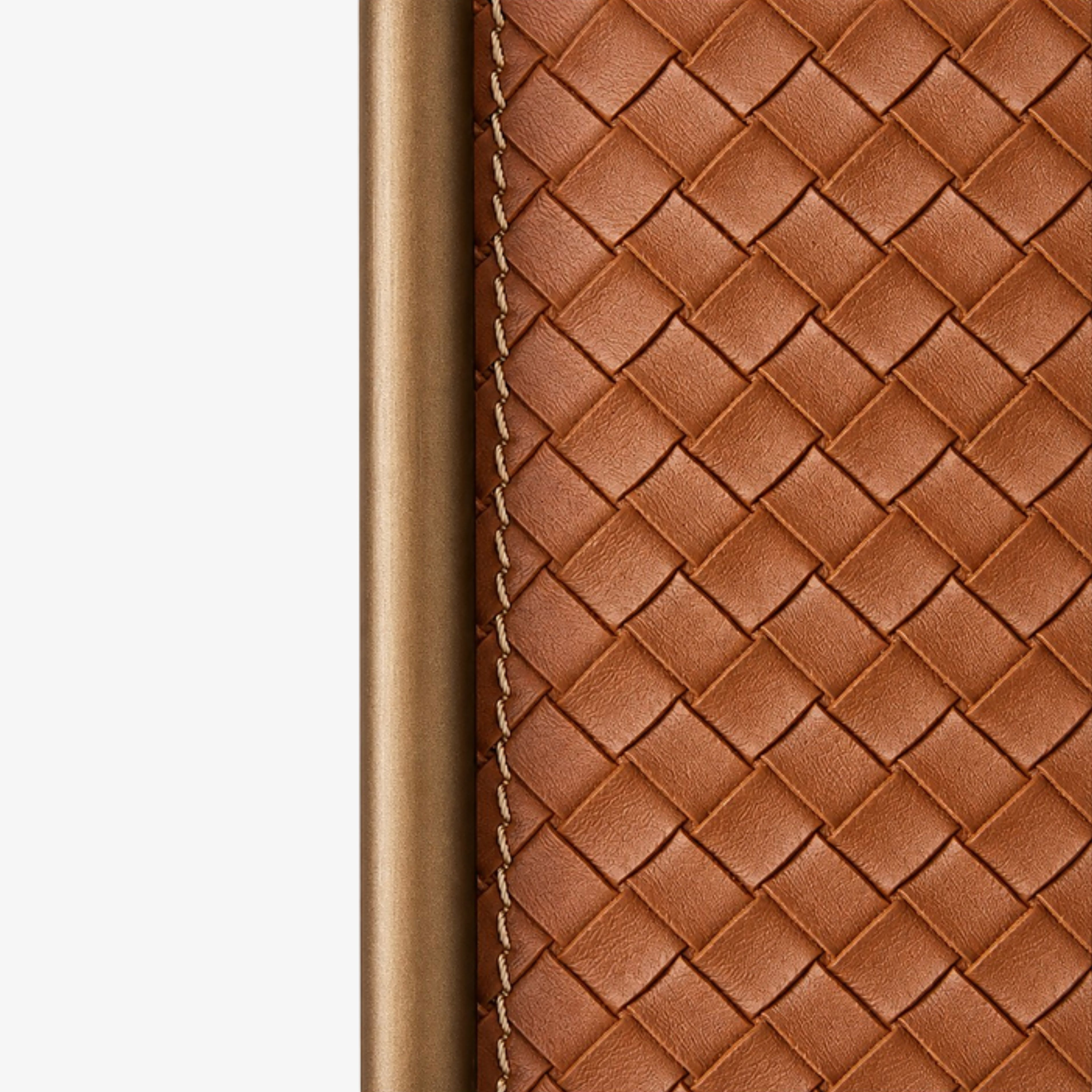 Woven leather edge stitching and antique brass frame detail