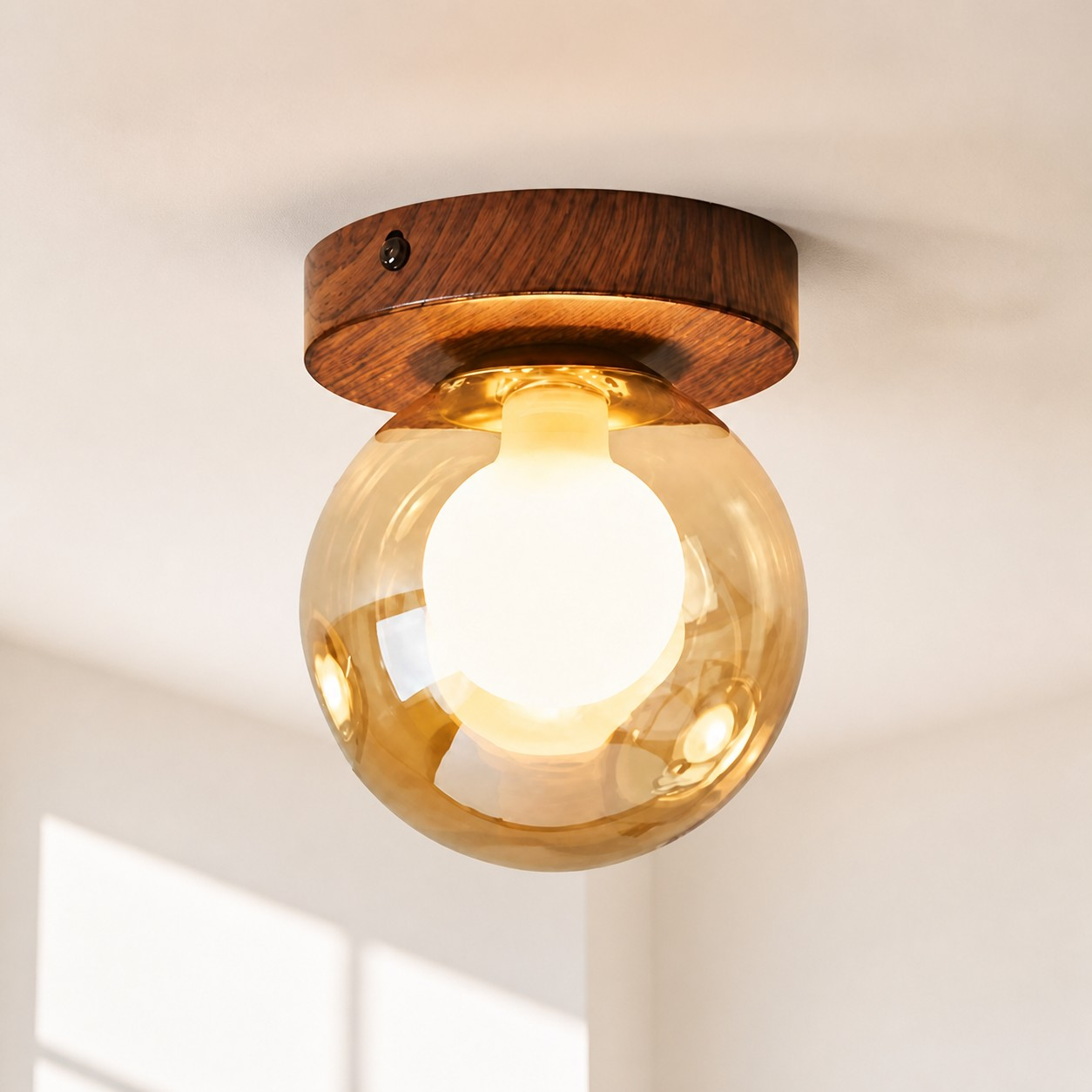 Amber glass globe wall lamp in a hallway
