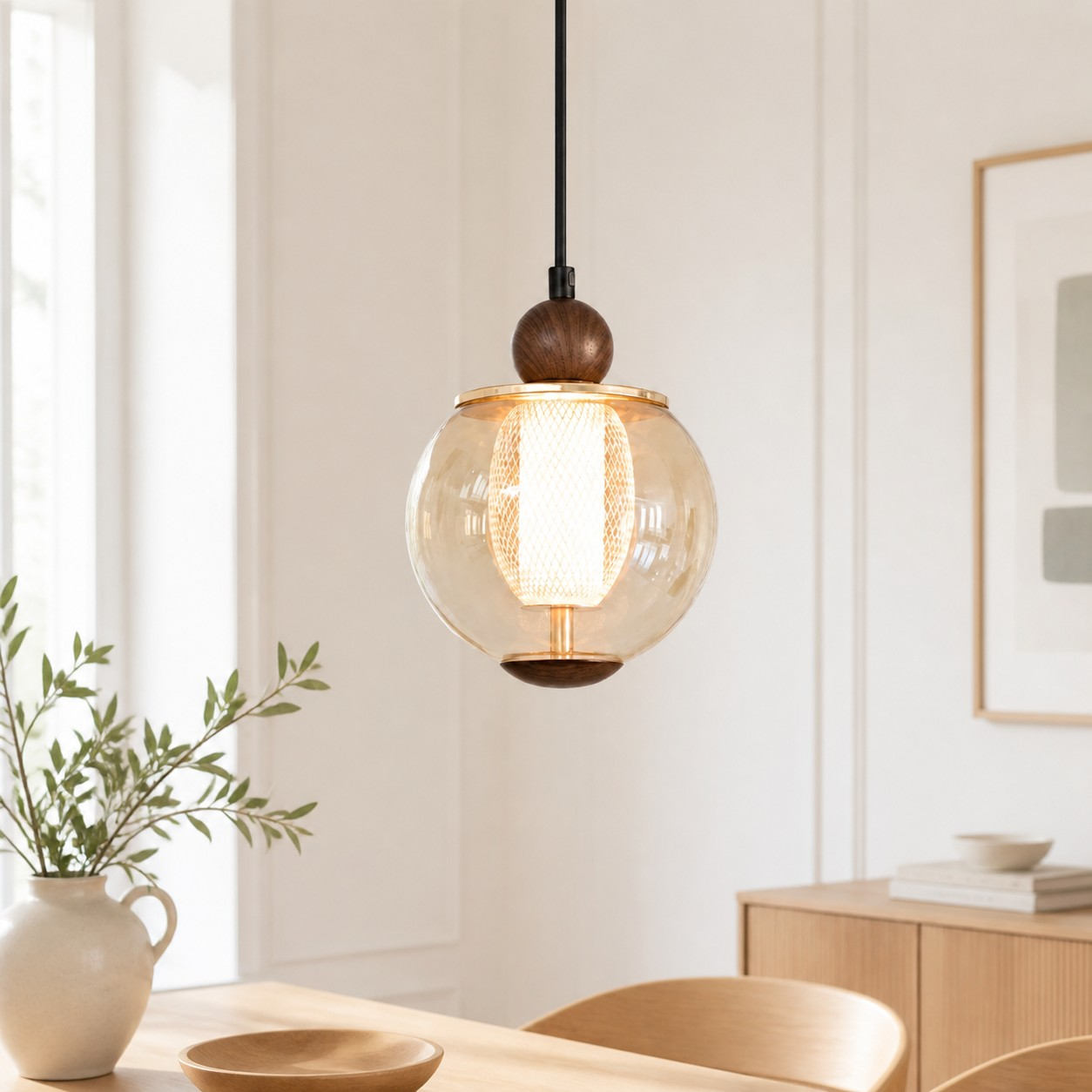 Single-head amber globe pendant above a dining table