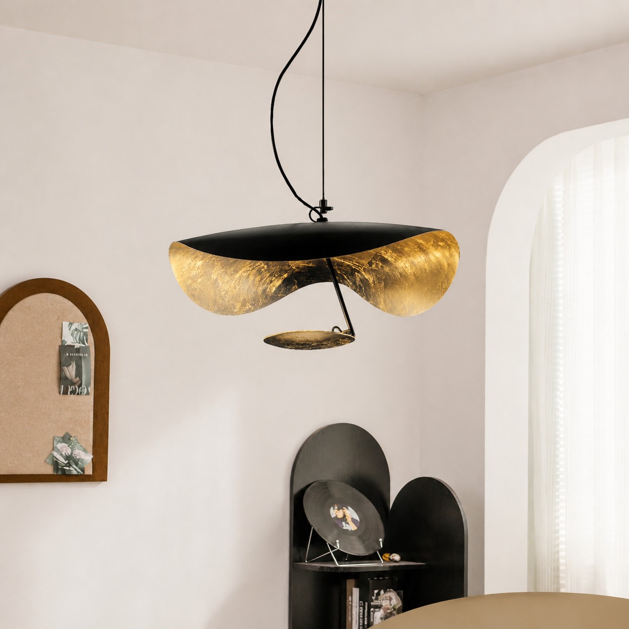 Black and gold sculptural pendant in a dining room