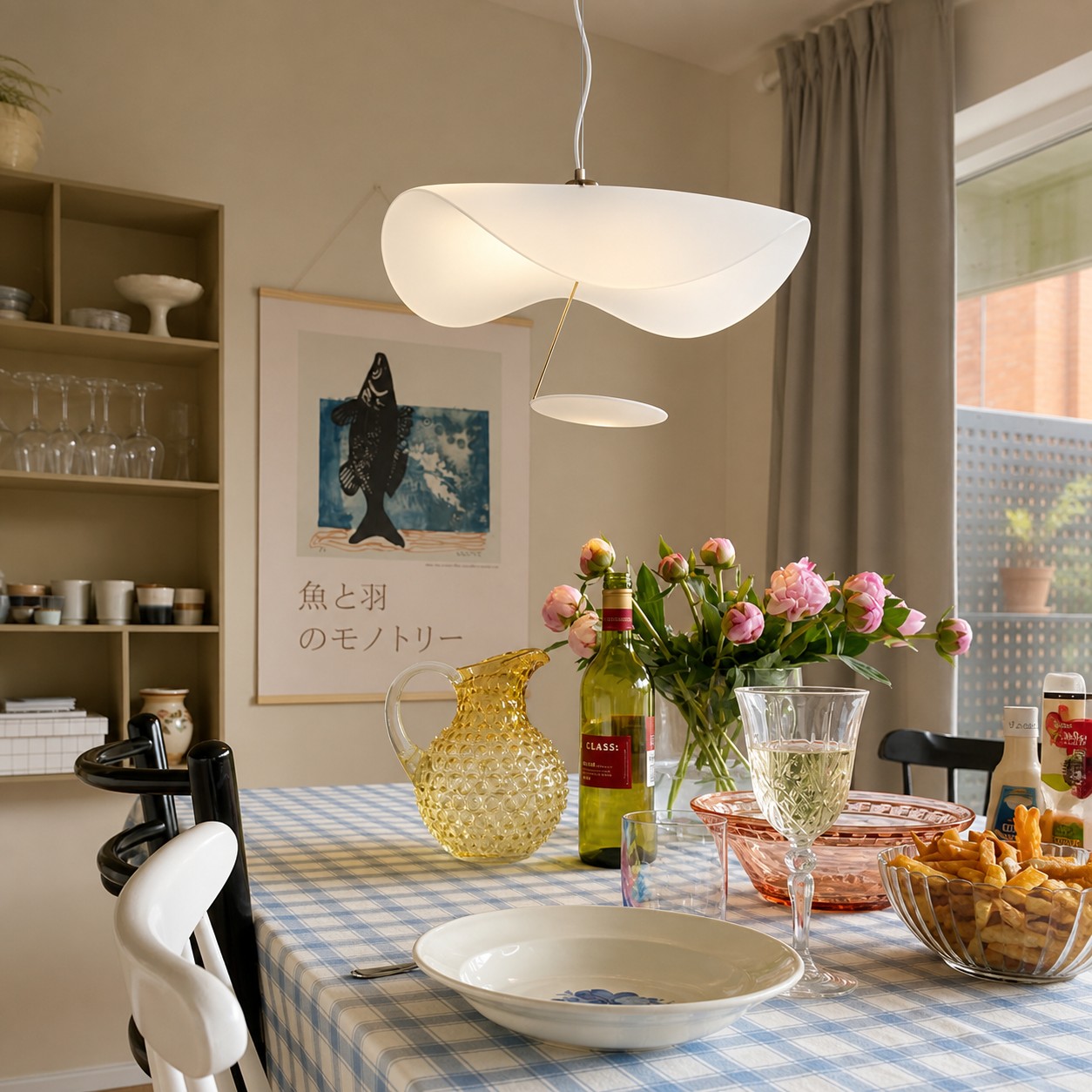White sculptural pendant lamp above a bright dining table