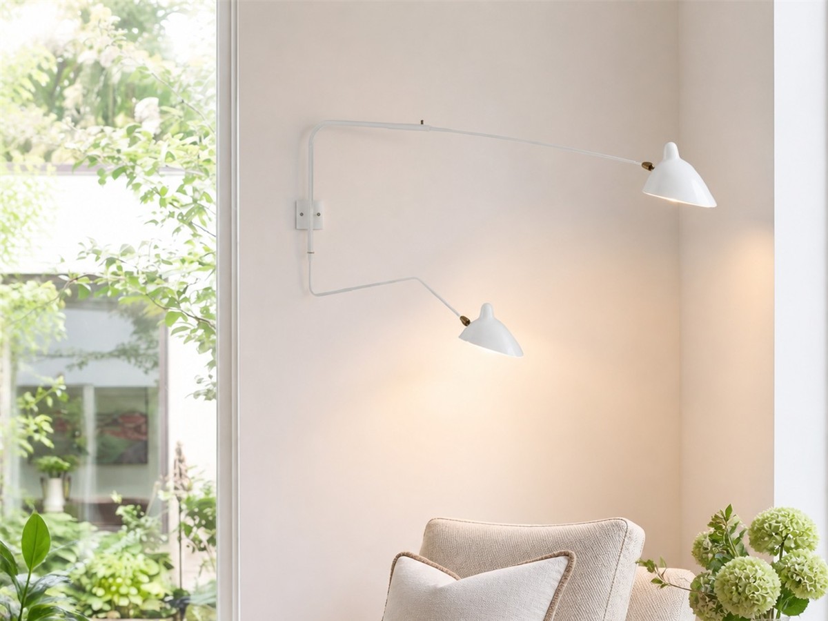 White Duckbill Wall Sconce beside a reading chair