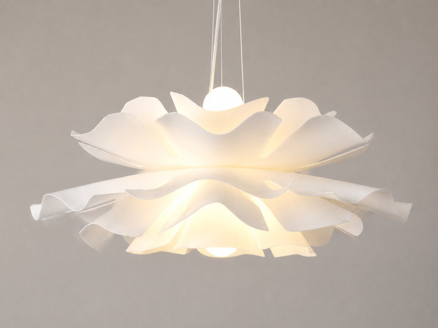 White Blossenari pendant lamp switched on