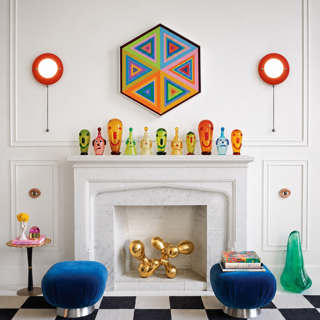 Red pull-chain wall lamps framing a colorful fireplace