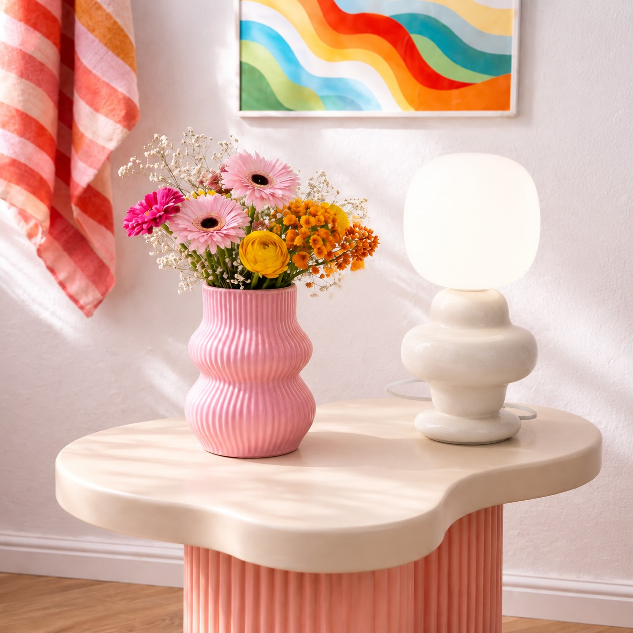 Cream sculptural globe table lamp beside flowers