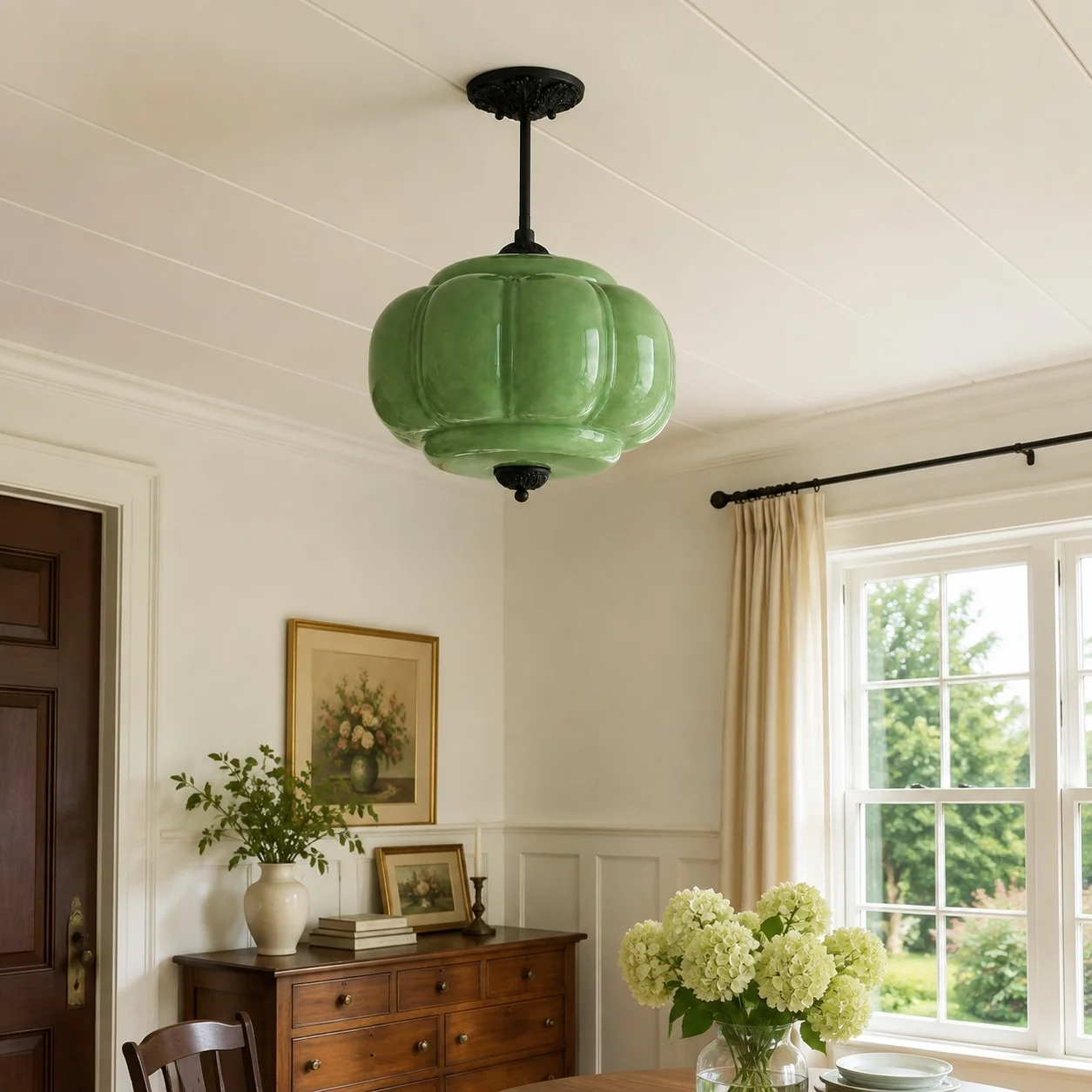 Green ribbed glass pendant with black metal hardware in a bright dining room