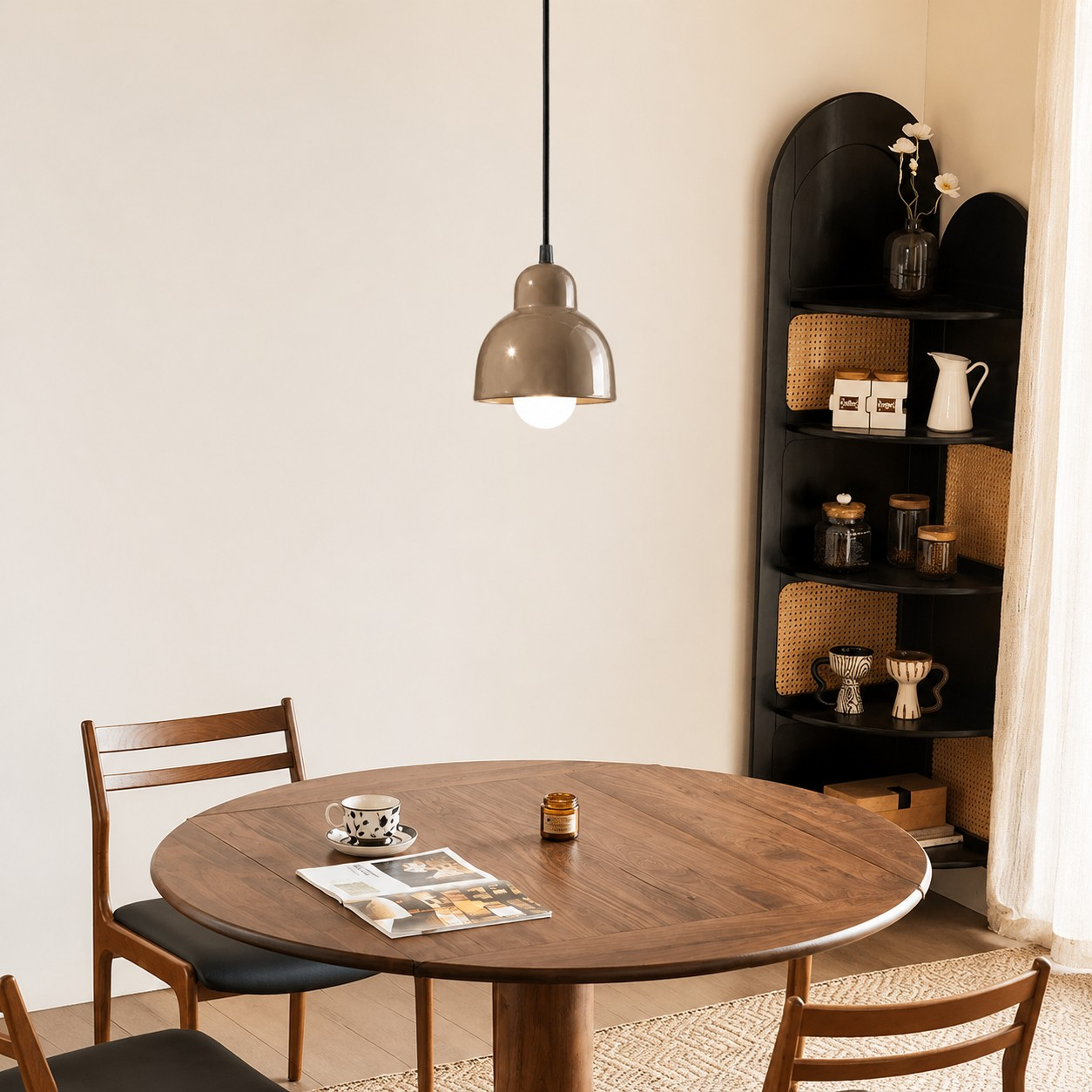 Gray ceramic pendant lamp over a round dining table