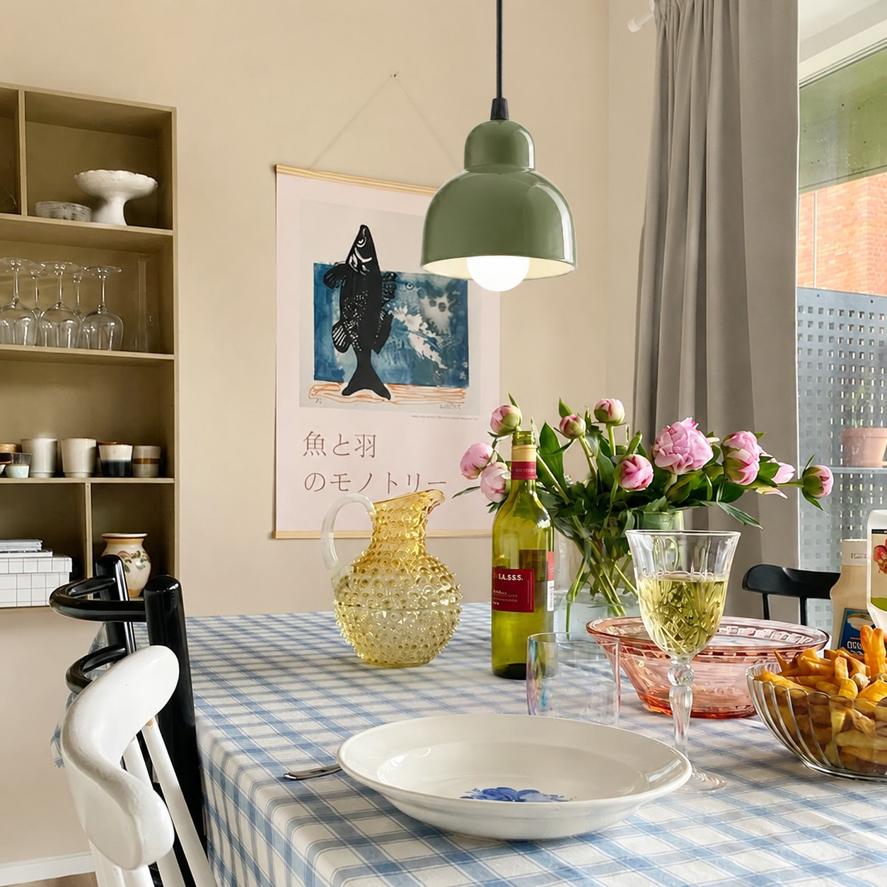 Olive green ceramic pendant lamp above a dining table