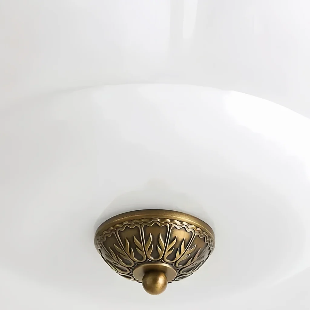 Ornate brass finial on white milk glass shade