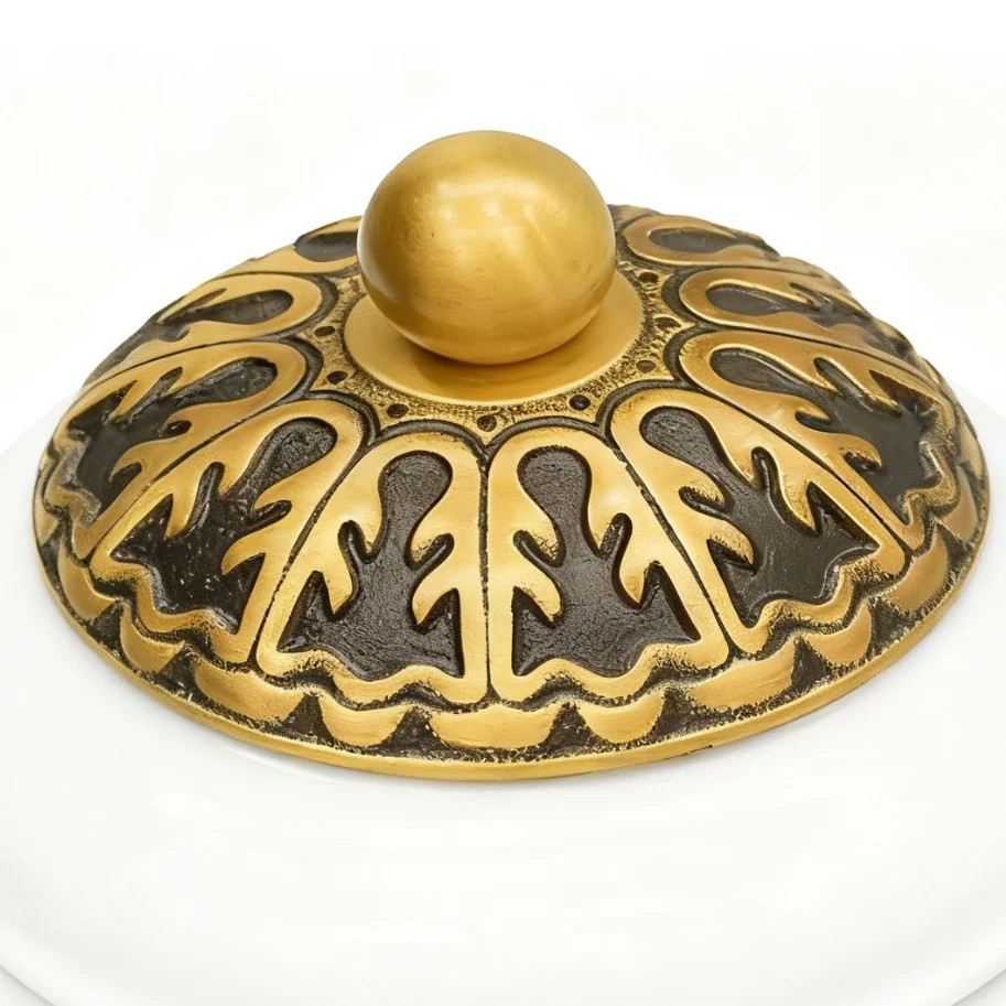 Ornate metal end cap and spherical finial detail