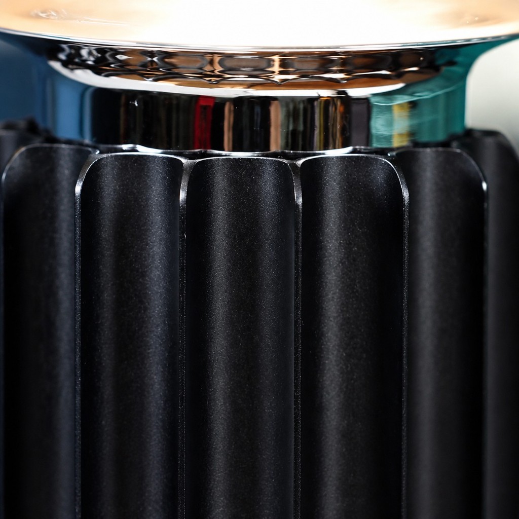 Close-up of fluted metal base and polished chrome collar on Taccia table lamp
