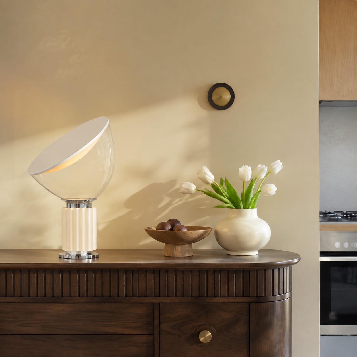 Warm white Taccia lamp on a fluted sideboard