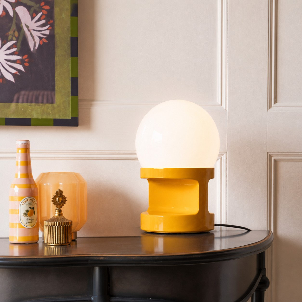 Yellow HABEA table lamp on a dark wood console