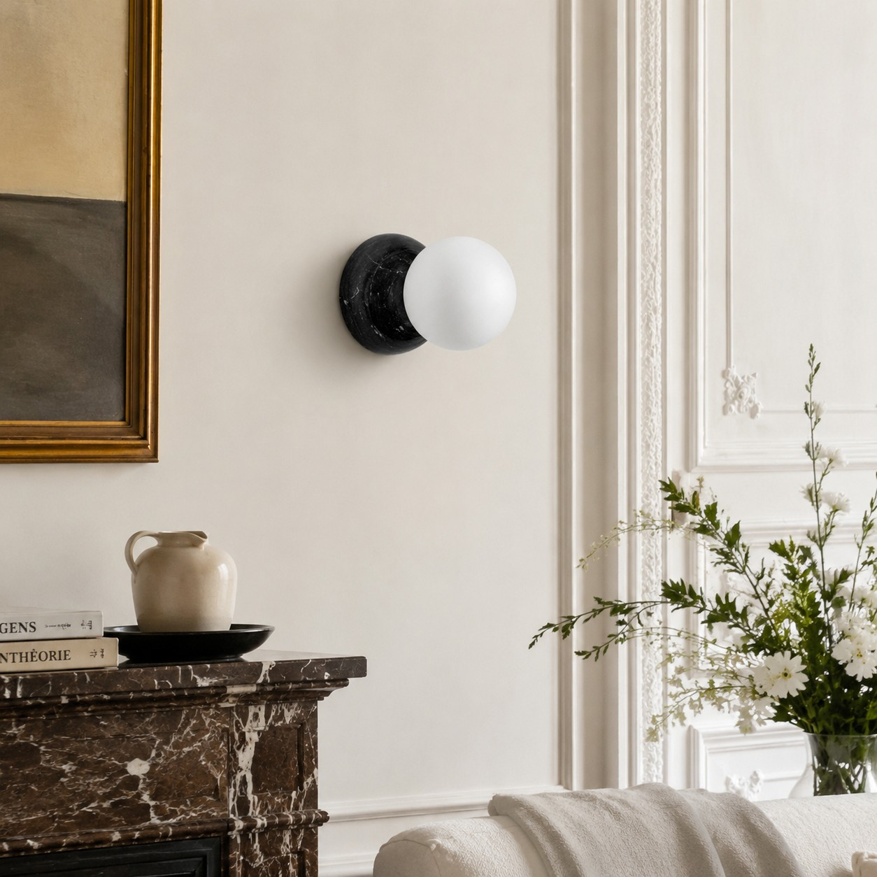 Black Marble globe wall sconce beside a stone fireplace