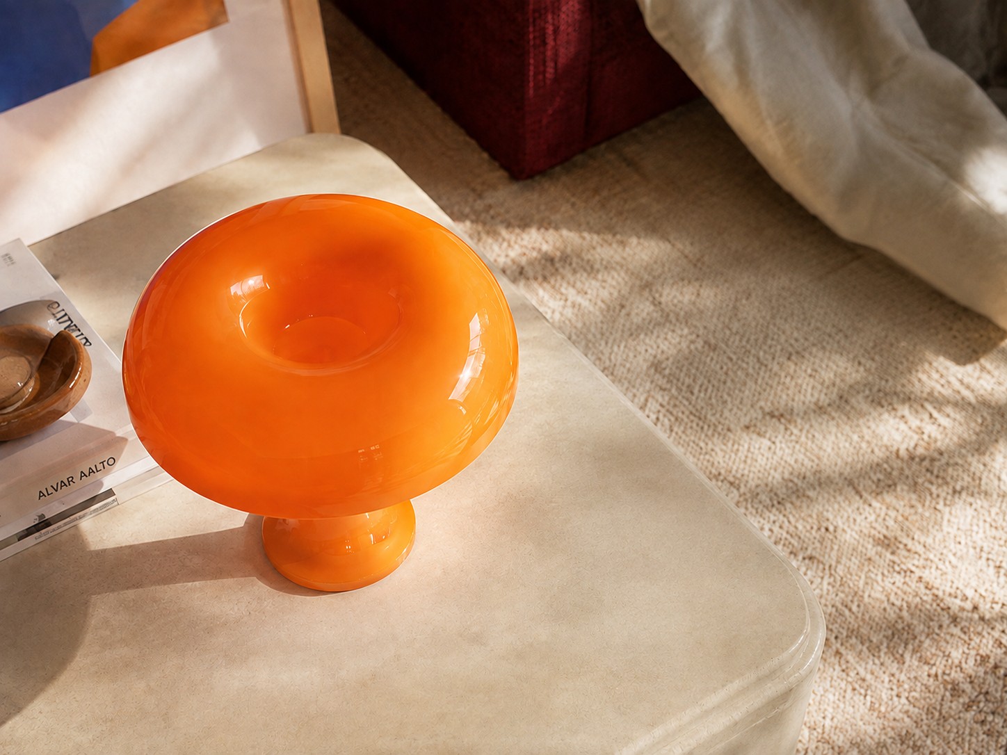 Orange sculptural table lamp in a warm autumn interior